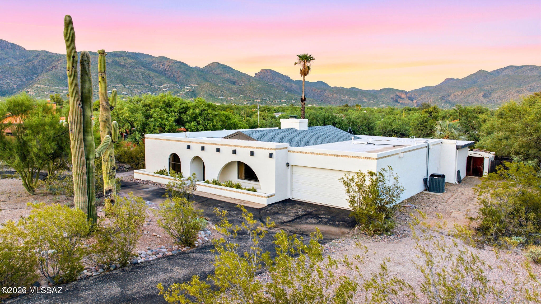 Perfectly positioned on Tucson's coveted northeast side, this private desert retreat offers the rare combination of peaceful seclusion and exceptional convenience! Surrounded by the natural beauty of the Sonoran Desert and framed by sweeping mountain views, the property embraces Arizona living at its finest while remaining just minutes from premier shopping, dining, hiking trails, golf, and everyday amenities.
Designed to blur the line between indoors and out, the home opens to expansive covered patios overlooking a sparkling pool, creating an effortless setting for entertaining or quiet evenings beneath Arizona's unforgettable sunsets. Mature desert landscaping, generous spacing from neighboring properties, and a tranquil natural setting provide a sense of privacy that's increasingly difficult to find!
Inside, spacious living areas are filled with natural light and anchored by a dramatic stone fireplace, while large windows invite the surrounding desert landscape into nearly every room. The thoughtfully designed floor plan offers comfortable everyday living with generous gathering spaces, well-appointed bedrooms, and timeless Southwestern character throughout!
Whether you're enjoying coffee as the sun rises over the mountains, hosting family and friends poolside, or simply appreciating the quiet beauty of the Sonoran Desert, this home delivers an authentic Arizona lifestyle in one of Tucson's most desirable locations!
Private. Peaceful. Perfectly connected. This is northeast Tucson living at its very best.