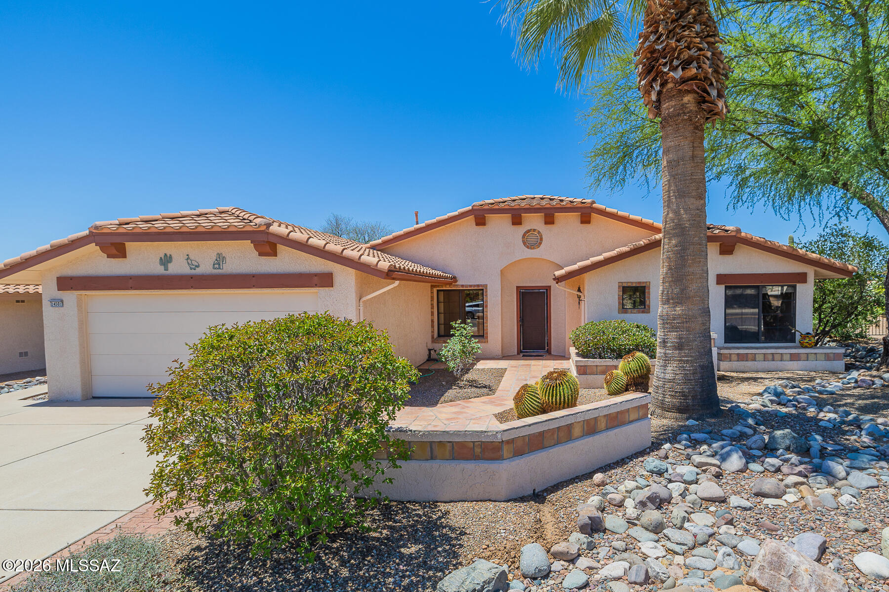 Beautiful home on an exceptional view lot in Sun City Oro Valley. Desirable Cumberland Floor Plan features hardwood floors, spacious greatroom and dining with a cozy gas fireplace. The extended patio has been expanded further to create an inviting large shady space for gracious outdoor Southern Arizona living. The oversized kitchen area include a bay windowed nook that looks out to the stunning Catalina mountains. The spacious primary has a wide bay window looking out to that wonderful patio. Garage features an dedicated area to park your golf cart + 220. This well maintained home has a 1 year old top of the line Lennox heating & cooling system, replaced pipes throughout and a water softening system. This home is move in ready. Golf Cart may be available with a separate bill of sale.