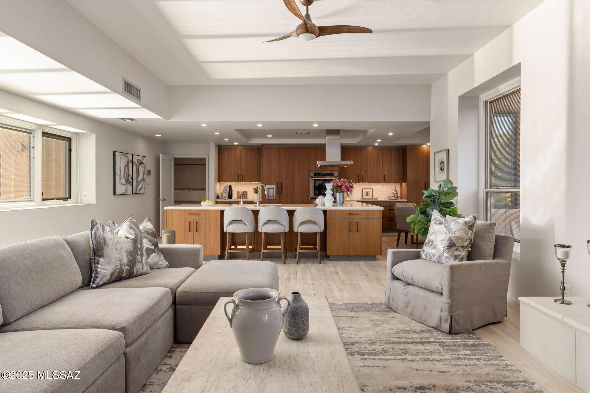 Experience elevated desert living in this beautifully updated Catalina Foothills home, where modern design meets everyday comfort. The chef's kitchen—expertly redesigned by HomeWorks Design—showcases sleek ArtCraft cabinetry, Thermador and other luxury appliances, and a refined aesthetic ideal for cooking and entertaining. Contemporary wood-look porcelain plank tile flows through the main living areas, while the remodeled bathrooms feature clean, modern finishes, and the secondary bedrooms enjoy soft, plush carpeting. Step outside to a professionally landscaped backyard retreat with a covered patio framing exceptional mountain views, plus raised container gardens and fruit trees. Notable upgrades include an owned solar system, newer HVAC systems (2022), and a 9-year remaining (continue roof recoat warranty, a newer water line, and an oversized two-car garage with added storage. The adaptable fourth bedroom, most recently utilized as an office, can easily become a private suite with a third bathroom, home gym, or playroom, offering outstanding flexibility to suit your lifestyle.