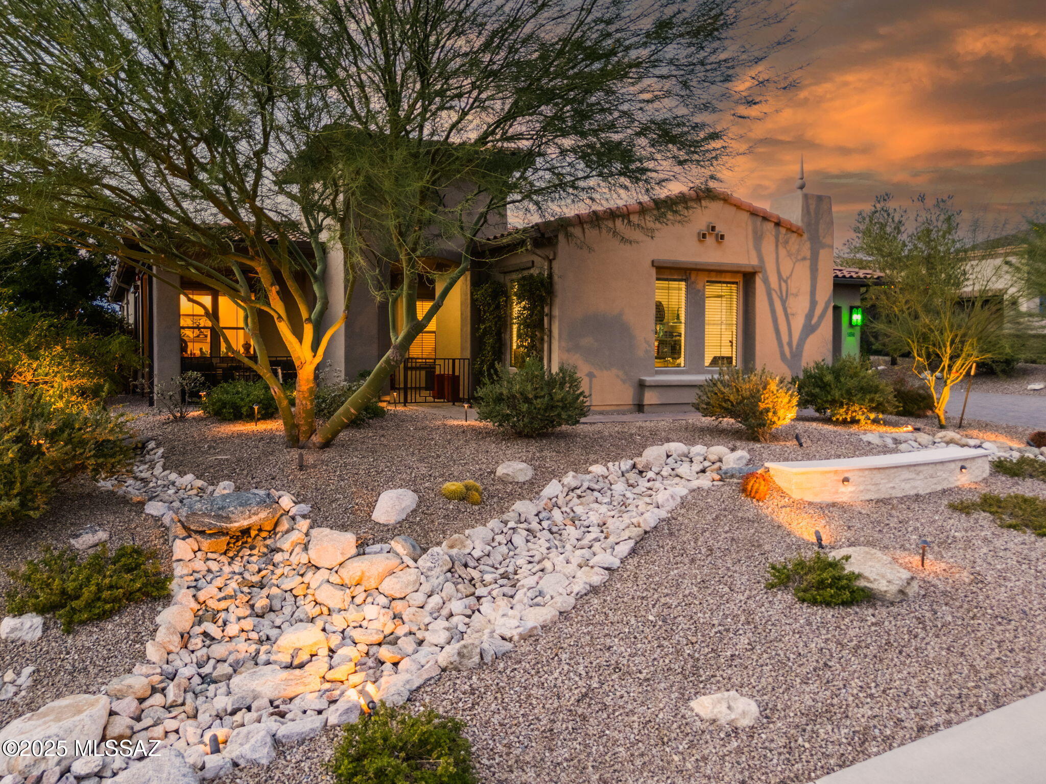 Set against the fairways of The Gallery South Course, this exceptional Toll Brothers residence in Los Saguaro at Dove Mountain delivers panoramic views of the Tortolita Mountains and Tucson's unforgettable sunsets.  Designed for effortless indoor-outdoor living, the expansive great room features a full wall of glass that opens to multiple patios and a covered porch.  Outdoor amenities create a private resort experience with a heated spool, gas fireplace, built-in BBQ, bar seating, raised lounge area, low-maintenance turf, and mature desert landscaping.  The open, highly sought-after floor plan is anchored by a gourmet kitchen ideal for entertaining while enjoying sweeping golf and mountain vistas.