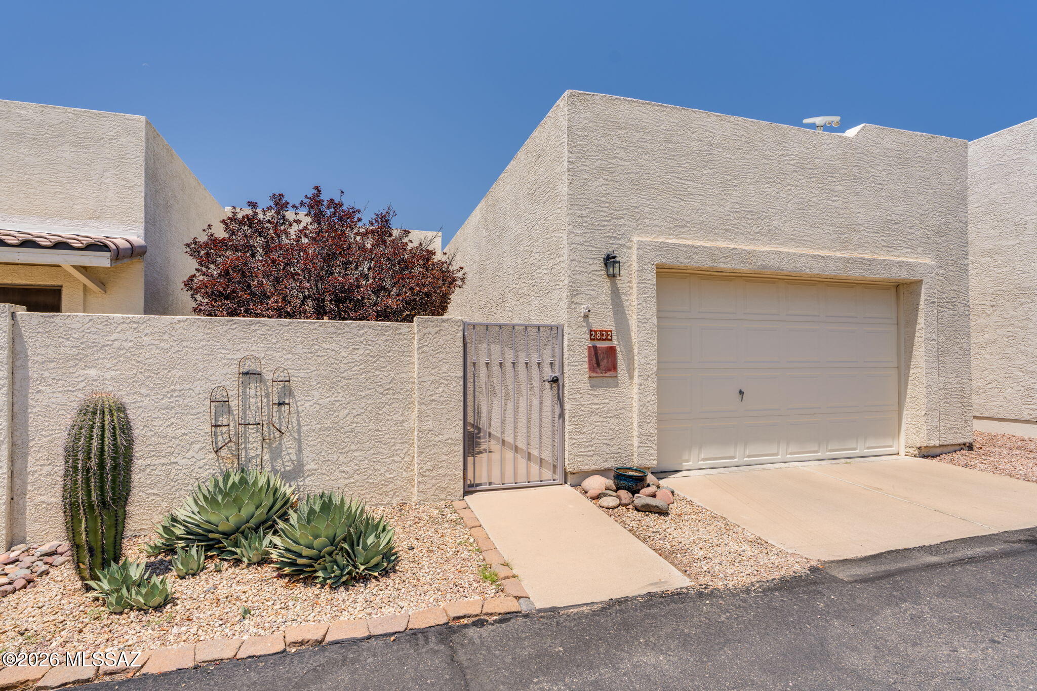 You will love this peaceful, low-maintenance 55 plus lifestyle surrounded by stunning mountain views. This inviting townhouse offers comfortable living near the Tucson Mountains, providing a quiet setting while remaining close to everyday amenities. The community's gated entrance, community pool & spa, & proximity to some of Tucson's most beautiful natural landscapes make it a hidden gem. Enjoy a front courtyard with low-maintenance desert landscaping, perfect for relaxing or entertaining. Inside, updated laminate flooring flows throughout most of the home, carpet only in the guest bedroom for added comfort. This well-designed floor plan maximizes both functionality & livability. The kitchen features convenient pull-out drawers & all appliances convey. Water heater replaced last year for added peace of mind. Perfect for full-time or seasonal living.  *As Is Seller unable to make any repairs