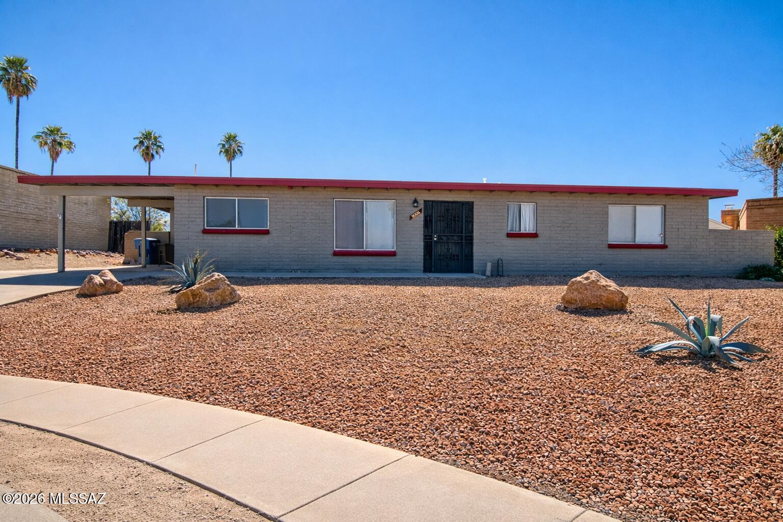 Welcome to this charming 4-bedroom, 2-bathroom home located on the east side of Tucson, just minutes from schools, restaurants, and shopping. Step inside to a spacious living room featuring a cozy fireplace, perfect for relaxing or entertaining. Tile flooring flows throughout the home, offering both style and easy maintenance.

The updated bathrooms add a fresh, modern touch, while the eat-in kitchen provides a comfortable space for everyday meals and gatherings. A dedicated laundry room and 2-car carport add to the home's functionality.

Outside, enjoy a large, low-maintenance backyard complete with gravel and pavers--ideal for outdoor seating, entertaining, or creating your own desert oasis. Move-in ready and thoughtfully maintained, this home offers comfort, and convenience!