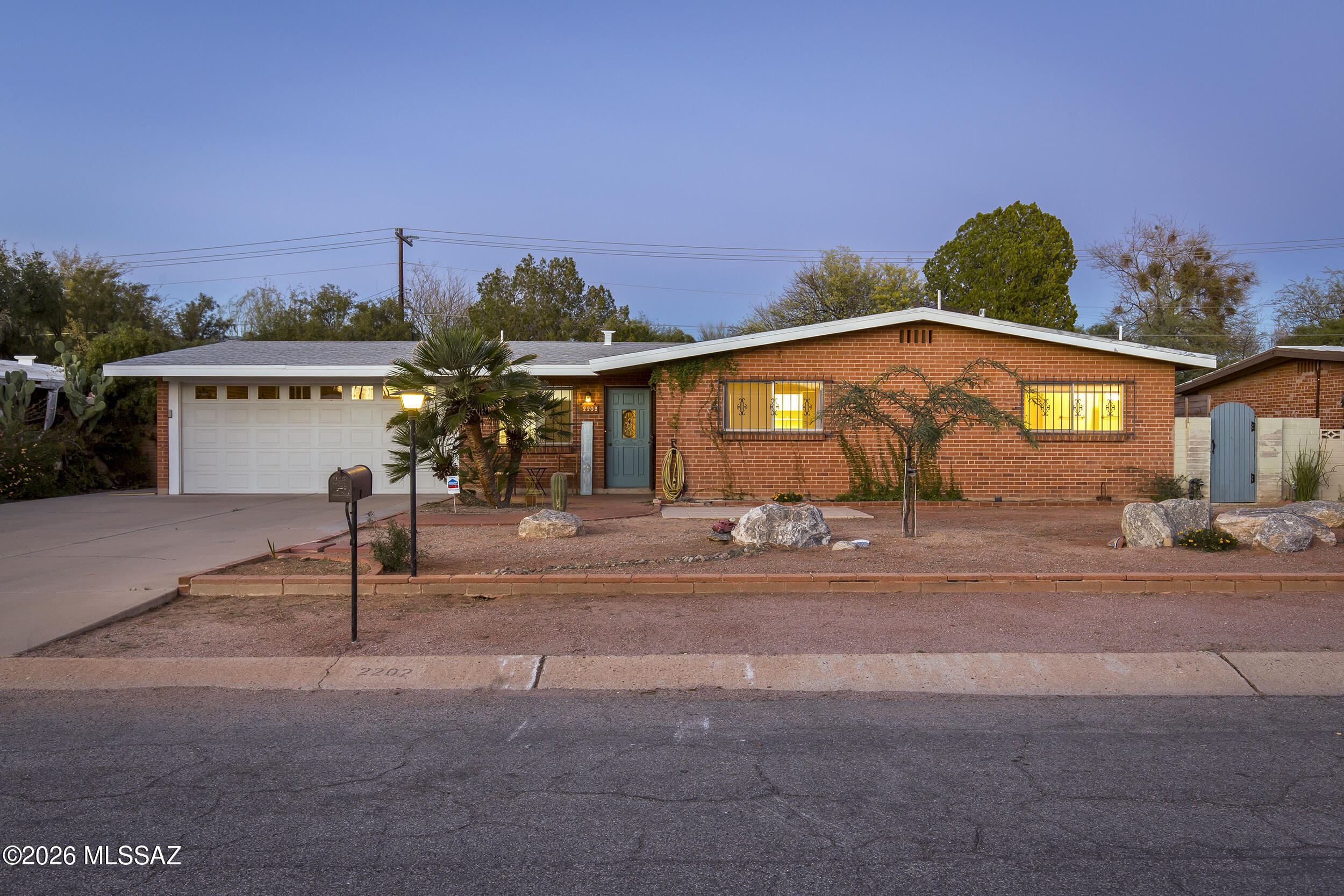 Charming double-brick home in a convenient central Tucson location, tucked into an established neighborhood. Main home features 2 bedrooms, 2 baths, a spacious great room with fireplace, and an expansive Arizona room spanning the back of the home for flexible living space. Wonderful galley kitchen offers ample workspace and functionality for everyday cooking and entertaining. Detached guesthouse with private entrance and full kitchen provides an ideal setup for multigenerational living, guests, home office, or rental income potential. Backyard includes a unique treehouse and room to enjoy outdoor living. Two-car garage with small workshop adds extra storage and functionality. A versatile property combining classic ranch style, solid construction, and income or guest opportunities.