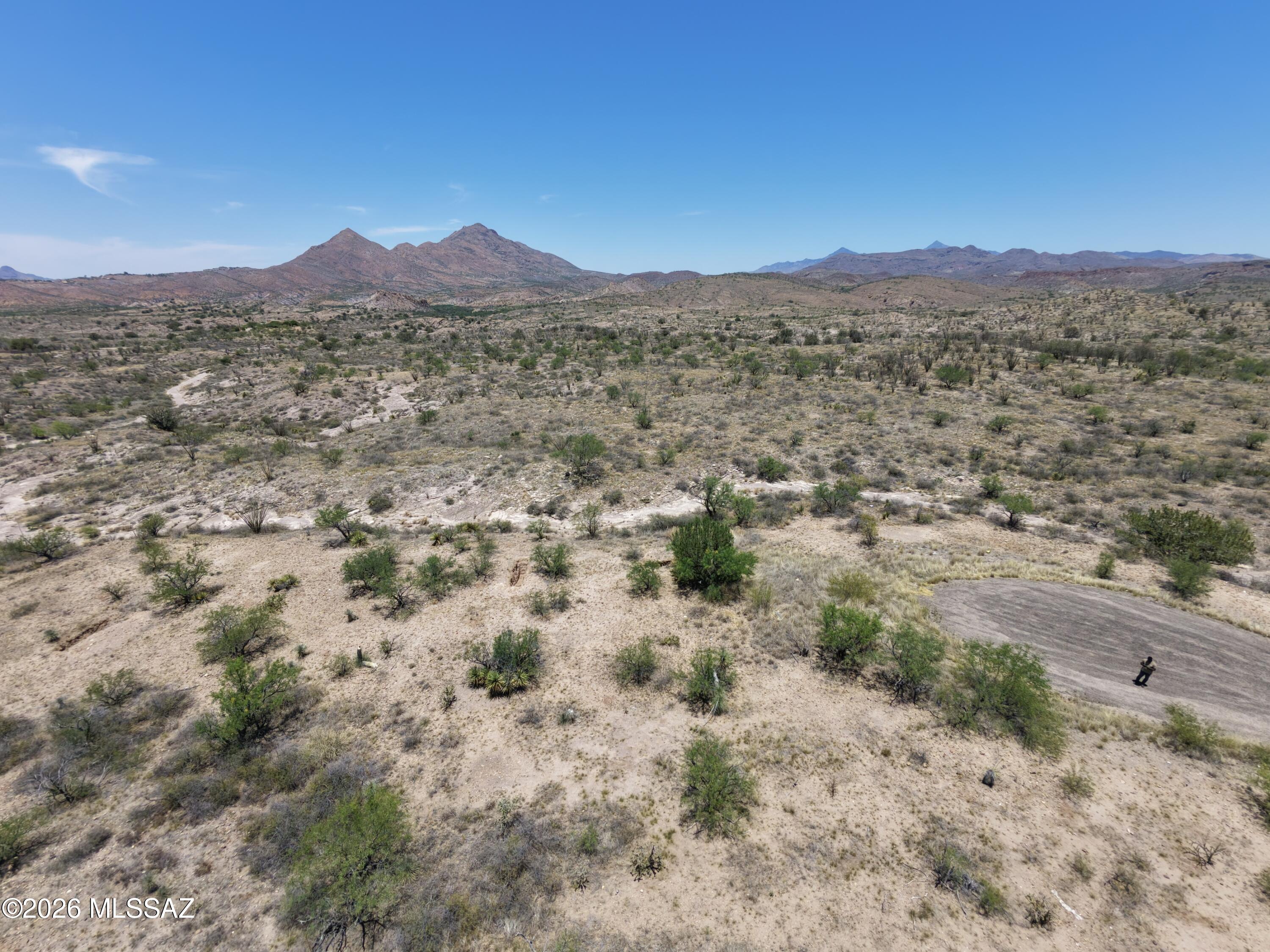 Discover the perfect setting for your next chapter in the rolling hills of Rio Rico. Tucked away on a quiet cul-de-sac, 1126 Teco Court offers a serene high-desert escape with sweeping panoramic mountain views & spectacular Arizona sunsets. Whether you are envisioning a custom architectural build, a peaceful winter retreat, or a smart land investment, this parcel provides a stunning natural backdrop framed by beautiful native vegetation. Enjoy the tranquility & darker skies of Santa Cruz County while remaining conveniently accessible to local amenities, golf, & the I-19 corridor for an easy drive up to Tucson.
Looking to expand your footprint? This property offers a rare double-lot opportunity. This lot can be purchased & seamlessly combined with the adjacent lot at 1128 Teco Court. Secur both parcels together to maximize your acreage & build a sprawling, private high-desert estate. Walk the property today & start envisioning the possibilities!