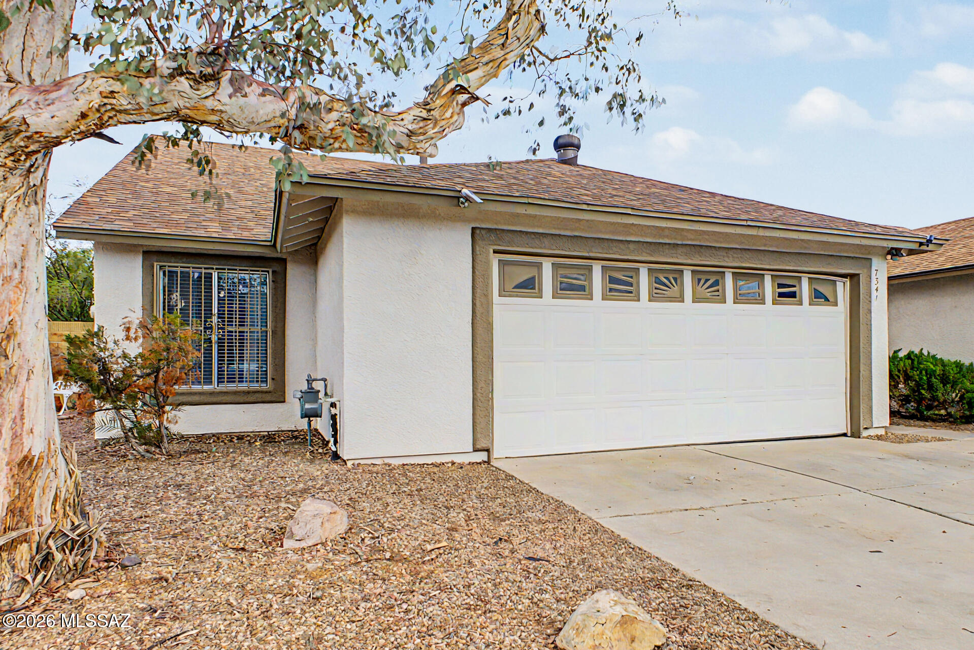 Check out this adorable single-story home with a charming curb appeal, an easy-care landscape, and a 2-car garage! Inside, you'll be greeted in a spacious great room with wood-look flooring, soaring vaulted ceilings promoting an airy feel, plenty of natural light, and a soothing palette that makes you want to stay. The pristine kitchen comes equipped with recessed lighting, white shaker cabinets, a peninsula with a breakfast bar, perfect for quick meals, and stainless steel appliances. The main suite promises a good night's sleep and hosts a private bathroom with dual sinks and a practical walk-in closet. The backyard features a covered patio perfect for weekend grills and peaceful evenings, pavers, artificial grass, and ample seating space. Hurry up, this gem won't last!