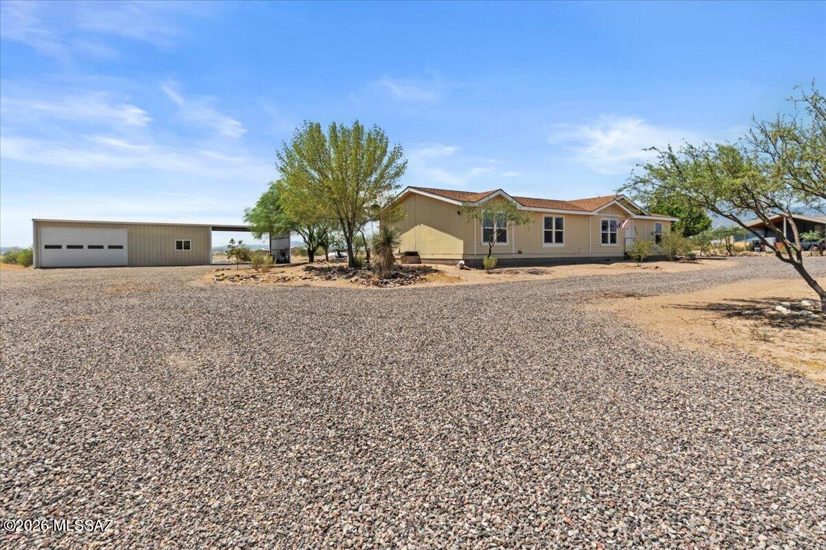 MOTIVATED SELLERS!! OFFERING $5k SELLER CONCESSIONS! with full price offer.
Welcome to this beautifully updated 3-bed, 2-bath home set on 2.5 acres with wide-open views and room to breathe. Inside, the home features a modern split bedroom floorplan, offering privacy and comfort for everyone. A formal living room sits at the front of the home, 
while the spacious great room brings together the dining area and updated kitchen - complete with a center island and breakfast bar perfect for casual mornings or entertaining. 
Just off the dining area is a large office space, ideal for remote work, hobbies, or a quiet retreat. The interior updates throughout make the home feel fresh, functional, and move-in ready. Step outside to enjoy a generous, covered porch with beautiful views as well as landscaped front and rear yard, perfect for hosting or quiet moments! This property also includes a newly built (2026), spray foam insulated 960 sq. ft. shop with full electric -- an incredible space for projects, storage, or equipment -- plus an attached carport for additional parking.
With acreage, views, and thoughtful upgrades inside and out, this property offers the perfect blend of comfort, utility, and rural Arizona living.