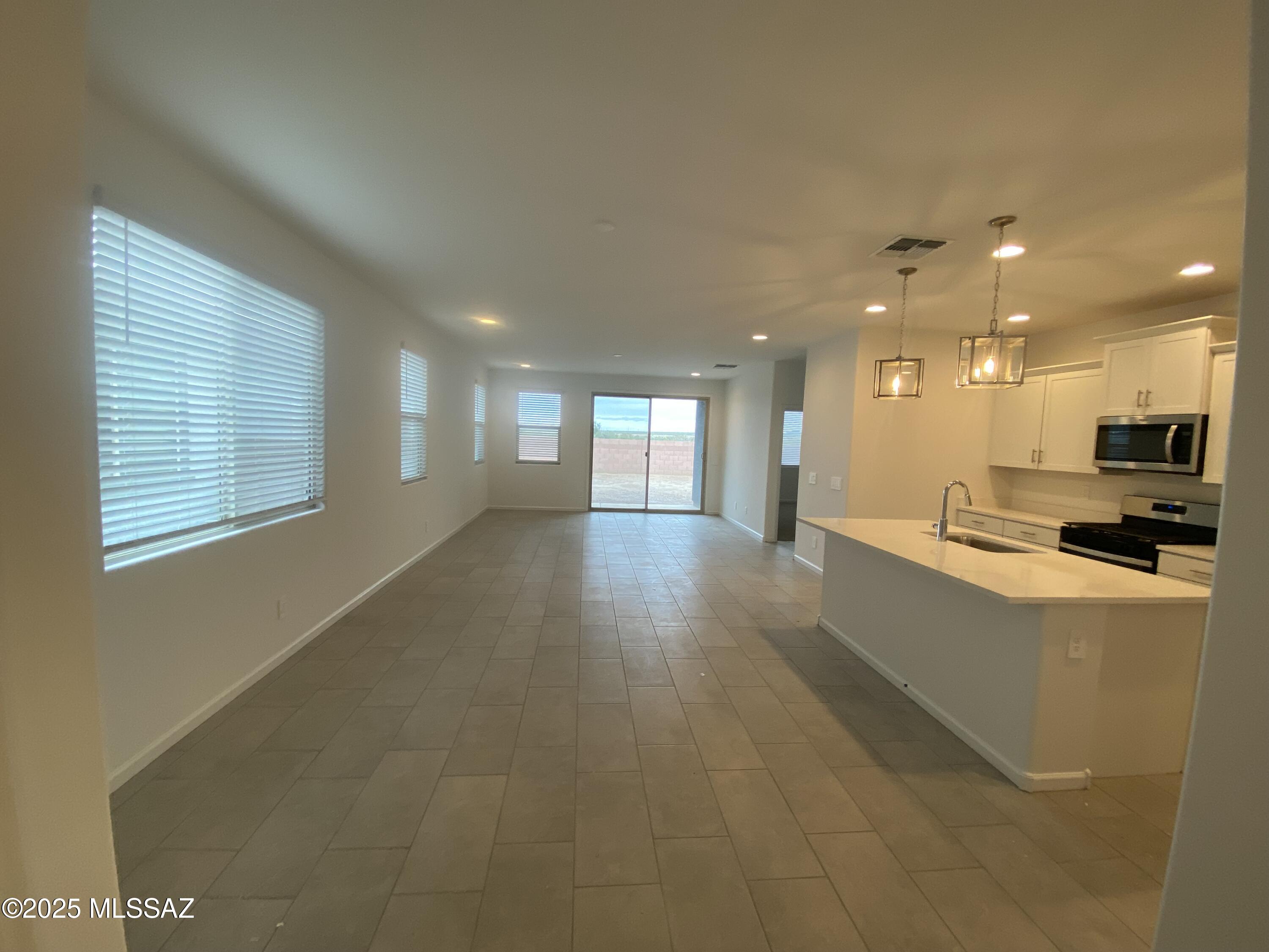 Open Layout. Energy Efficient. Move in Ready.

BRIGHT OPEN DESIGN
The Citrine floorplan features an inviting open layout with a spacious kitchen and covered patio--perfect for entertaining and everyday living. Designer finishes from the Finesse package include white cabinets, white quartz countertops, light beige tile flooring, and cool neutral carpet. Located in the desirable Mandarina community in Marana, offering amenities like a pool, pickleball courts, playgrounds, a dog park, and more. Move-in ready with washer, dryer, fridge, and whole-home blinds included.