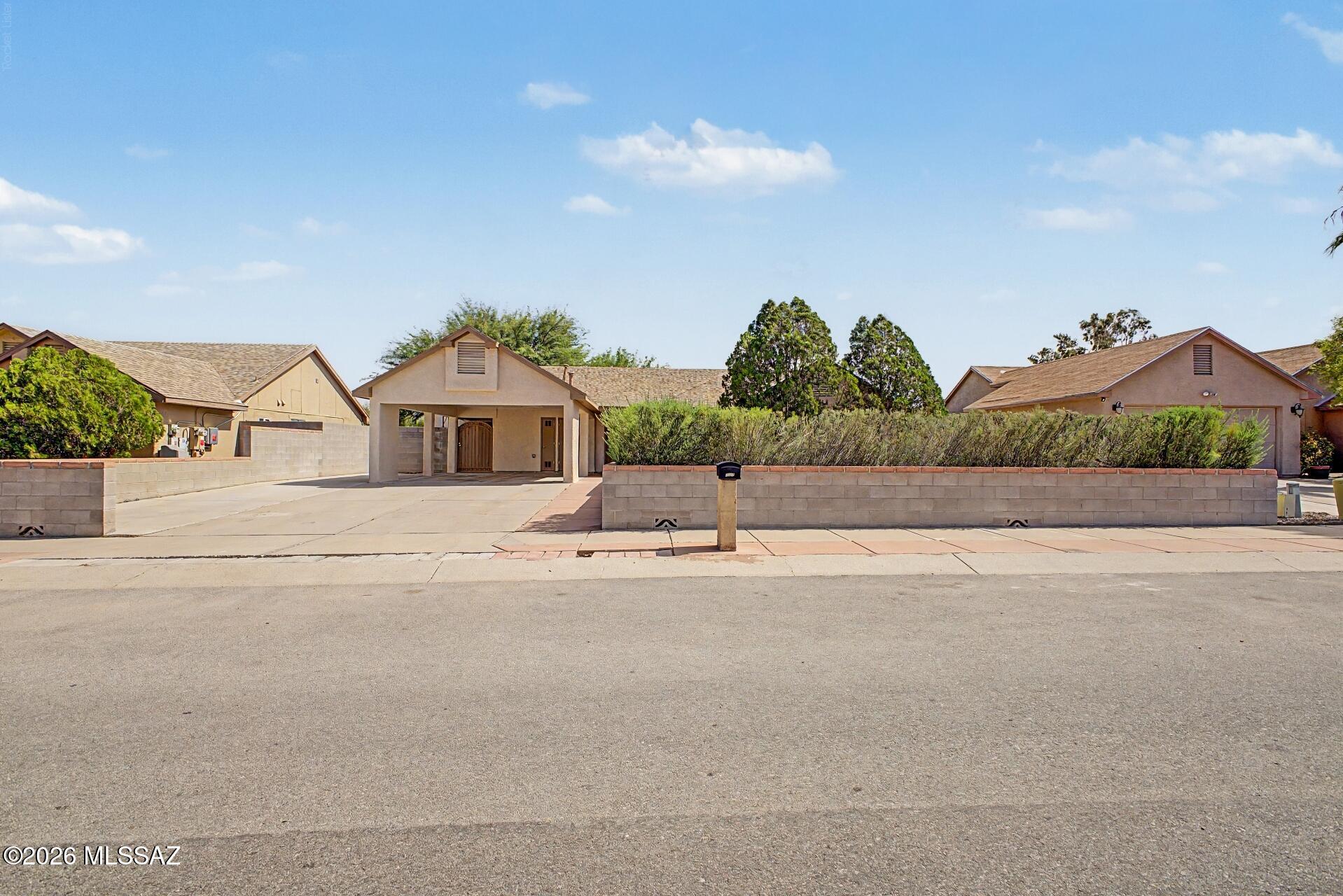 Completely Remodeled 4-Bedroom Home with Workshop and Exceptional Outdoor Living

Welcome to 3237 W Avenida Manana, where thoughtful design and meticulous craftsmanship come together to create a truly move-in-ready home. From the moment you arrive, you'll appreciate the fully paved driveway and spacious two-car carport, offering ample parking and outstanding curb appeal.

Step inside to discover a beautifully remodeled interior featuring warm natural tones and brand-new ceramic tile flooring that flows seamlessly throughout the home. The inviting great room creates an open and comfortable gathering space, ideal for both everyday living and entertaining.

At the heart of the home is the stunning kitchen, thoughtfully updated with gorgeous quartz countertops, sleek stainless steel appliances, and modern finishes that blend style and functionality. The split-bedroom floor plan provides privacy and flexibility, with the spacious primary suite separated from the additional bedrooms.

All four bedrooms and two bathrooms have been tastefully renovated, continuing the home's cohesive design and quality finishes. Quartz countertops extend into the bathrooms, adding a touch of elegance throughout.

A unique bonus feature is the attached air-conditioned workshop/storage space, perfect for hobbies, projects, additional storage, or a flexible workspace.

Step outside to enjoy the beautifully maintained front and back yards, designed with a low-maintenance combination of gravel landscaping and mature trees. The backyard is a true retreat, offering abundant shade and plenty of space to relax, entertain, or enjoy Tucson's beautiful weather year-round.

Completely remodeled inside and out, this exceptional property offers the perfect combination of modern upgrades, functional living space, and comfortable outdoor enjoyment. Don't miss the opportunity to own a home where every detail has been carefully considered.