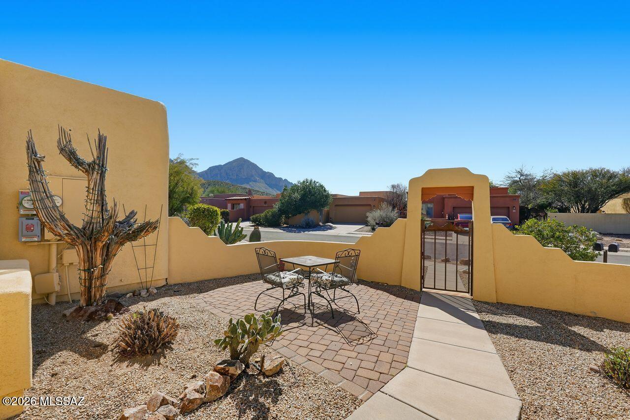 Classic TJ Bednar Sante Fe architecture, located in desirable community of Rams Canyon. The home features a spacious outdoor area with inviting patio setting, perfect for enjoying entertaining or quiet relaxation. The interior boasts a warm color palette and rustic charm with exposed beams, a stone accented fireplace, and vaulted ceilings that create a sense of openness and natural lighting throughout the open concept floor plan. Kitchen is updated with granite counters, serving beverage or prep bar and stainless appliances. The split bedroom layout affords privacy and separation, while the great room design allows for seamless flow & versatility. The homes cul de sac location offers a peaceful setting with mountain views front and back.  You'll never want to leave! Welcome Home!