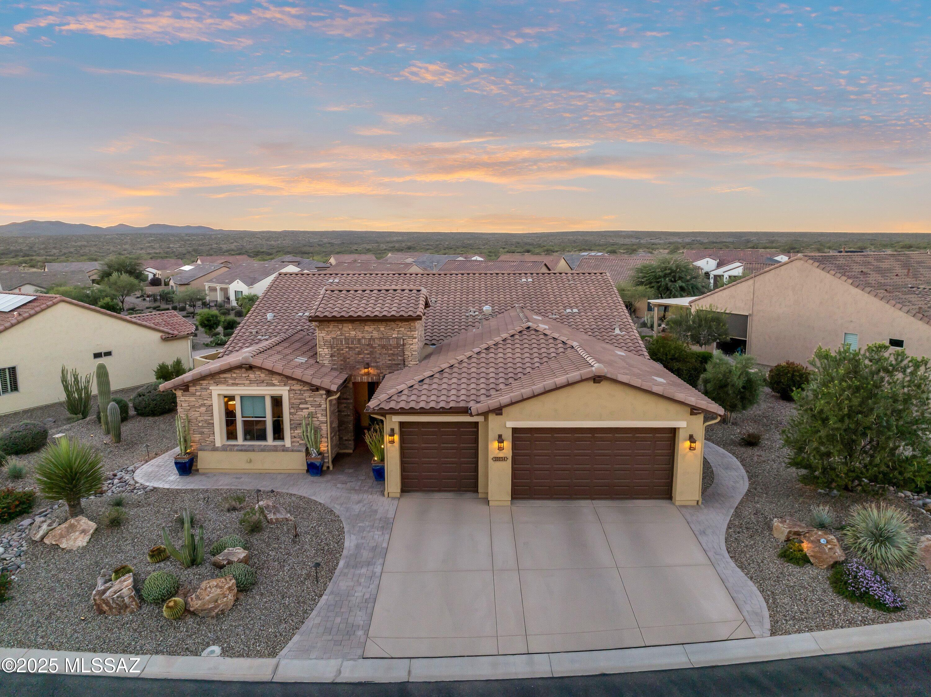 Mountain views await in this exceptional Vienta model showcasing thoughtful upgrades & premium finishes throughout. Turnkey Opportunity / Furnishings Included! The gourmet kitchen features Premier GE appliances, an electric cooktop, Blanco undermount sink, upgraded quartz countertops, & a full backsplash accented by pendant lighting & under/over cabinet illumination. Smart storage solutions include base cabinet rollouts & a dry bar w/beverage cooler, perfect for entertaining. The interior offers comfort & style w/newly carpeted bedrooms, and den, custom closet systems, & elegant shower/bath tile surrounds. A 2' master suite extension & 2' guest room extension, along with an en suite guest room, provides spacious accommodations. Laundry room is fully equipped w/upper & lower cabinets, full closet, washer/dryer, utility sink, & hang bar. Outdoor living shines on the premier lot, complete w/full fencing, pergola, privacy wall, solar screens, fireplace, firepit, & built-in BBQ/bar w/granite countertop. The garage is equally impressive, offering a 4' extension, storage cabinets, workbench w/under-cabinet lighting, textured epoxy floor & driveway, plus an HVAC mini-split for year-round comfort.