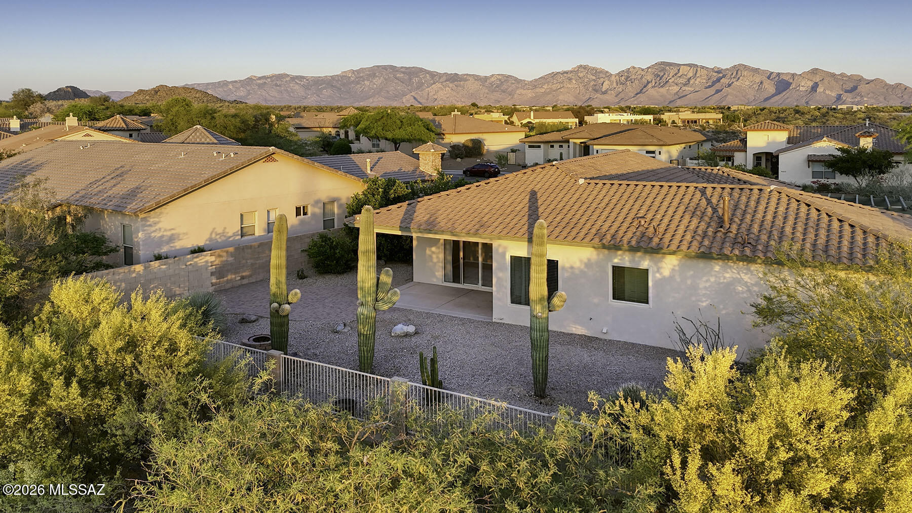 Beautifully crafted by renowned builder David Baird, this solidly built home is nestled in the sought-after Dove Mountain area, offering privacy with no neighbors behind and breathtaking mountain and sunset views. The newly remodeled kitchen is a standout, featuring high-end appliances including an ILVE gas range and KitchenAid refrigerator, custom cabinetry, quartz countertops, and convenient bar seating--perfect for both everyday living and entertaining. The open-concept floor plan seamlessly connects the dining area and casual eat-in space, creating a light and inviting atmosphere. The spacious primary suite offers a relaxing retreat with a large soaking tub, dual vanities, a separate tiled shower, and a generous walk-in closet. Two additional guest bedrooms provide flexibility for visitors, office space, or hobbies. Situated on a stunning lot adorned with mature saguaros and citrus trees, the expansive backyard offers plenty of room to add a pool and fully enjoy the Arizona lifestyle. A long driveway provides ample parking, and with no neighbors behind, you'll appreciate the added privacy and serenity. Recent updates include a new roof, carpet, custom blackout drapes, as well as newer windows, HVAC system, and hot water heater--making this home as functional as it is beautiful.