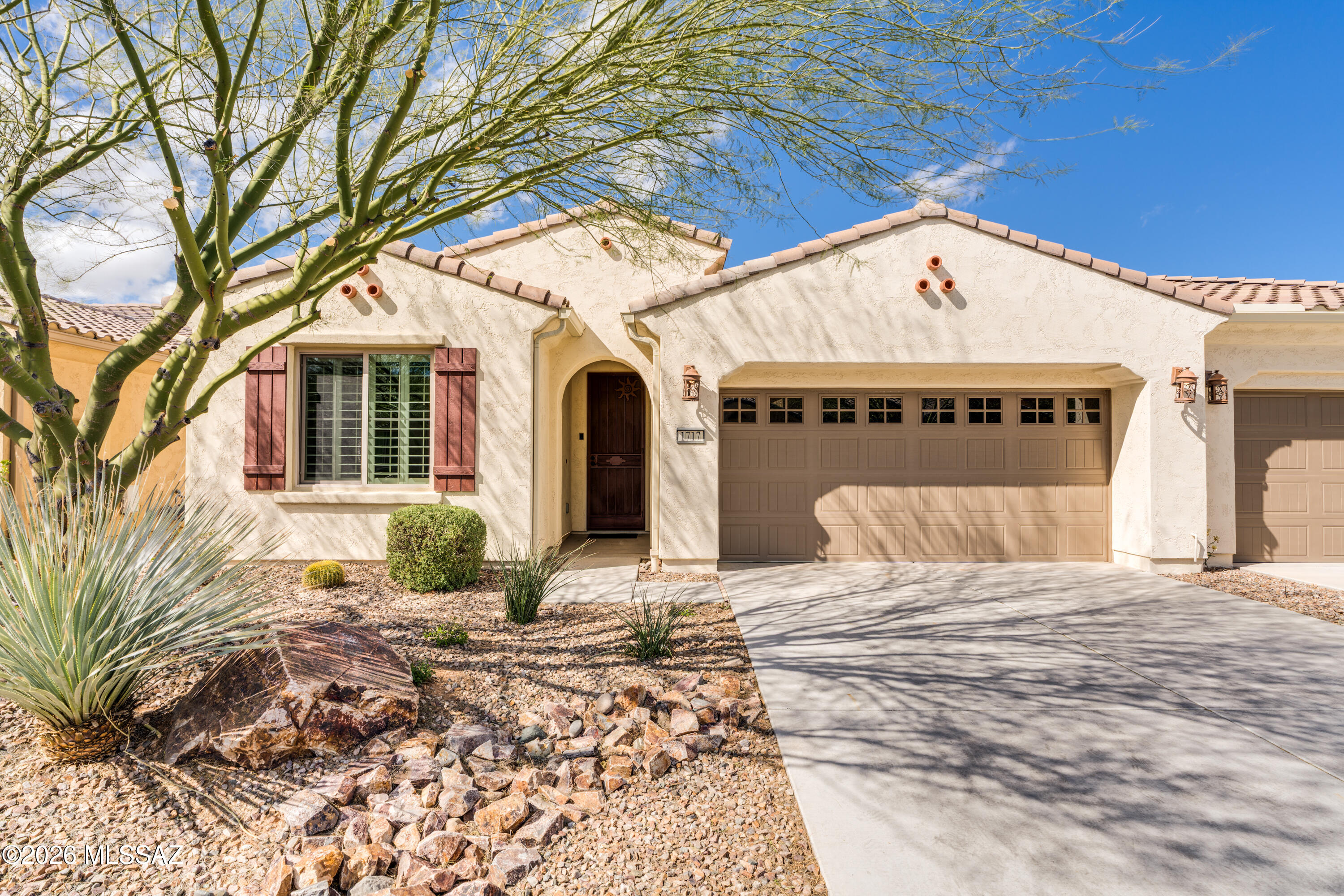 This low-maintenance Villa in Quail Creek offers easy living in the popular Primrose model. With 1,447 sq. ft., 2 BR, 2 BA, plus a versatile den, this home is ideal as a full-time residence, seasonal retreat, or investment property. A welcoming foyer opens to a spacious great room with ample space for both living and dining. Enjoy all hard-surface flooring throughout -- tile in the foyer, guest room, and baths, and wood-look luxury vinyl plank flooring in the kitchen, great room, den, and owner's suite. The upgraded kitchen features granite countertops, stainless appliances including a gas range, pantry closet, and a large island with breakfast bar, composite sink, and stylish pendant lighting. Plantation shutters, upgraded ceiling fans, and designer lighting enhance the home throughout. The owner's suite offers a dual-vanity bath with quartz counters, decorative tile backsplash, comfort-height toilet, all-tile shower, and a spacious walk-in closet. The den includes pocket doors for privacy, making it ideal as a home office or optional third sleeping area for guests. Step outside to the rear paver courtyard to enjoy peaceful sunset views and a lush common area backdrop. Designed for true lock-and-leave convenience, the HOA covers hazard insurance, exterior paint, roof maintenance, window and exterior maintenance, landscaping, irrigation, and common area upkeep--making retirement living effortless and worry-free.