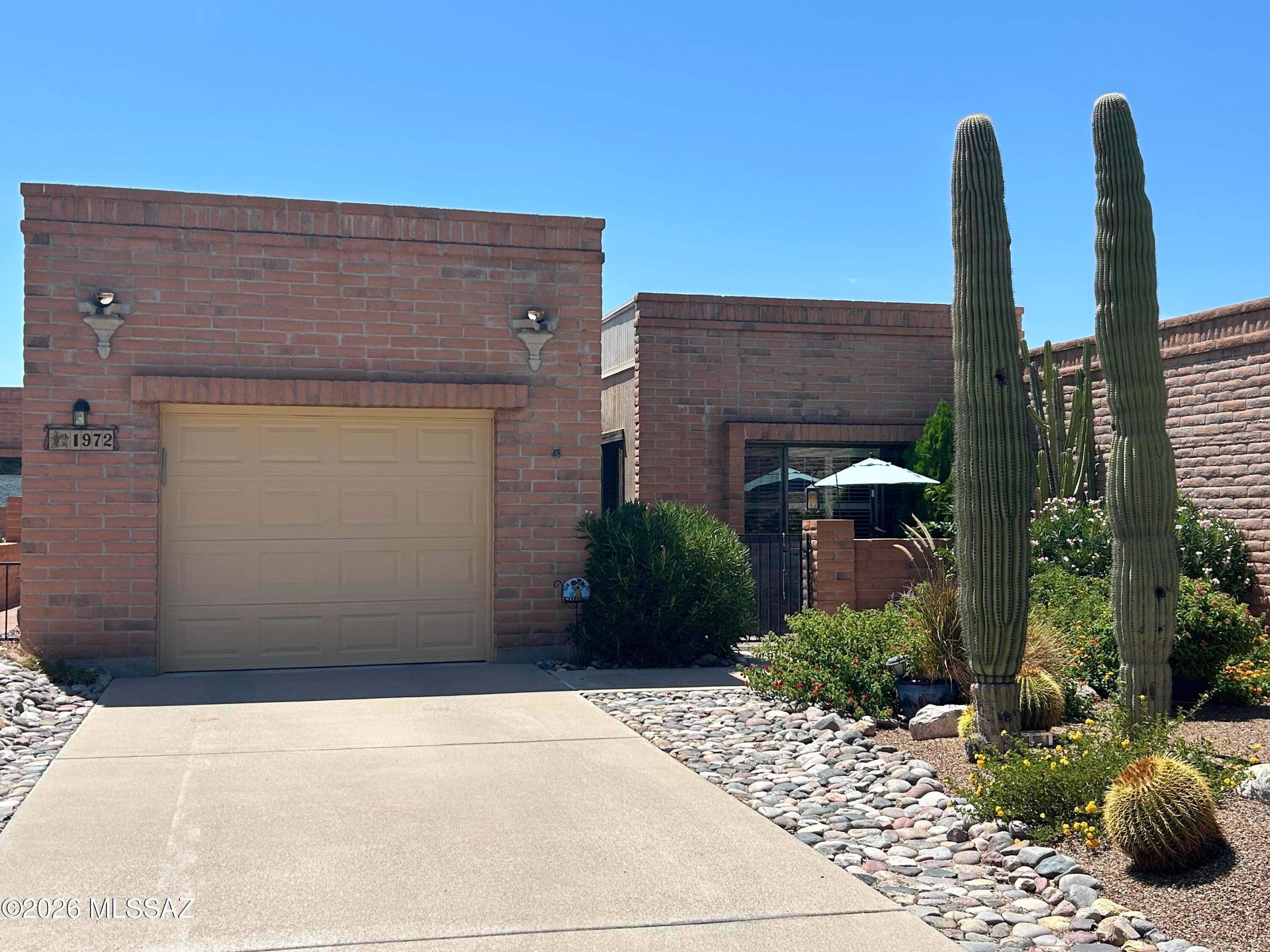 Immaculately maintained Townhome In popular La Cholla Hills. Conveniently located to shopping, medical facilities, and the new town center at Ina & La Cholla. Enter this home through a lush courtyard, the fountain stays! This home has newer vinyl wood flooring and ceramic tile for easy maintenance. The kitchen features Corian counters and stainless appliances. The separate laundry room is a bonus. This home has tons of storage with built in cabinets in the garage. Enjoy the beautiful back yard with lush landscaping and views of the Tortolita Mountains. This home will pleasantly surprise you!