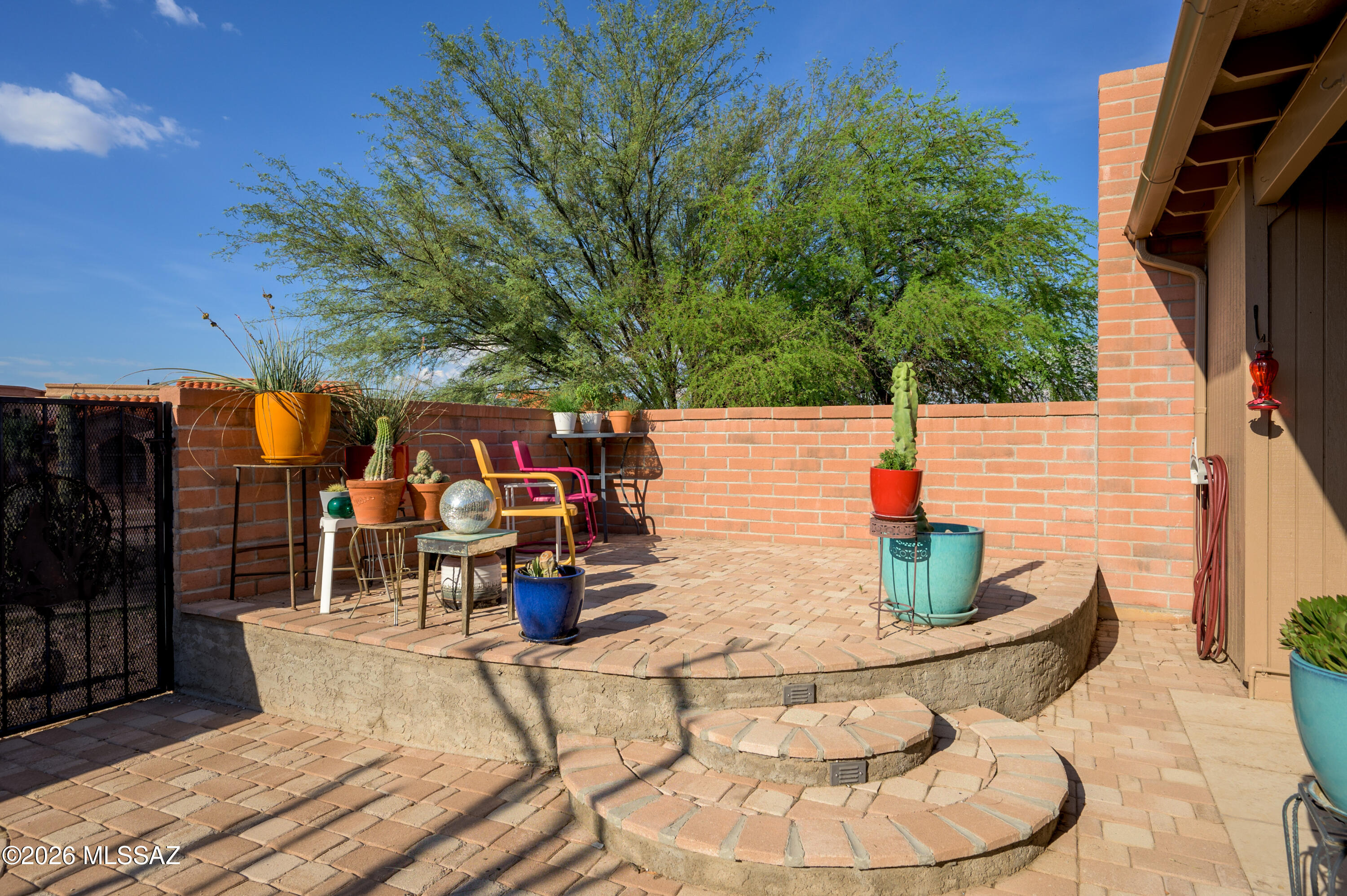 Welcome to a retirement lifestyle that embraces both privacy and stunning natural beauty. This desirable end-unit townhome offers complete seclusion, with breathtaking views of the untouched desert common area to the east and the majestic Santa Rita Mountains from your living room and backyard patio. Enjoy morning coffee or evening relaxation on your unique raised patio, where the sights and sounds of the Southwest surround you.  Inside, you'll find low-maintenance, solid-surface flooring throughout, making daily living and cleaning a breeze. The efficiently designed kitchen boasts a large skylight, flooding the space with warm, natural light. With two bedrooms and two bathrooms, this home is perfectly sized for comfort and easy living.  Step outside to your large, north-facing covered patio, providing cool shade throughout the day, plus an expansive brick paver area--ideal for outdoor dining, gardening, or simply soaking up Arizona's celebrated climate. Located in the friendly Canoa Seca Estates, you'll enjoy convenient access to multiple Green Valley Recreation Centers. Embrace an active, yet leisurely lifestyle with endless social activities, clubs, and amenities available through your GVR membership. Experience the best of Southwest Arizona retirement living--peaceful, scenic, and full of opportunity!