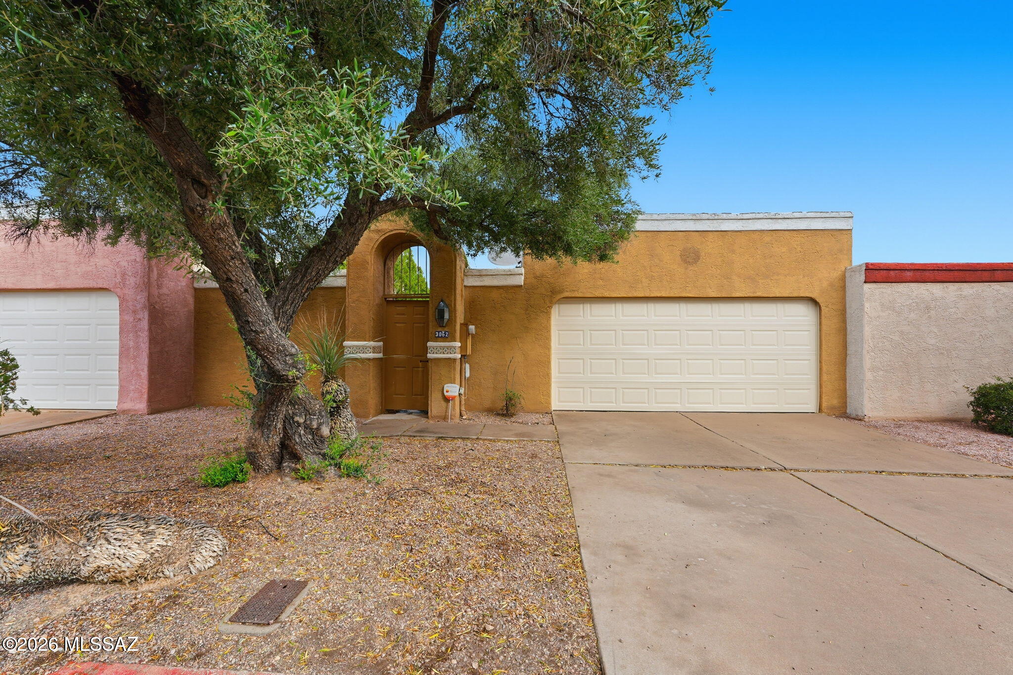 Charming Southwestern-style townhome with great potential! Featuring vaulted ceilings, Saltillo tile flooring, fireplace, and a spacious living area filled with natural light. Kitchen offers ample cabinet space and a functional layout ready for your personal touch. Generous primary suite with private bath and patio access. Private backyard with covered patio--perfect for relaxing or entertaining. Convenient location near shopping, dining, and amenities. Home is being sold as-is. A fantastic opportunity to update and make it your own!