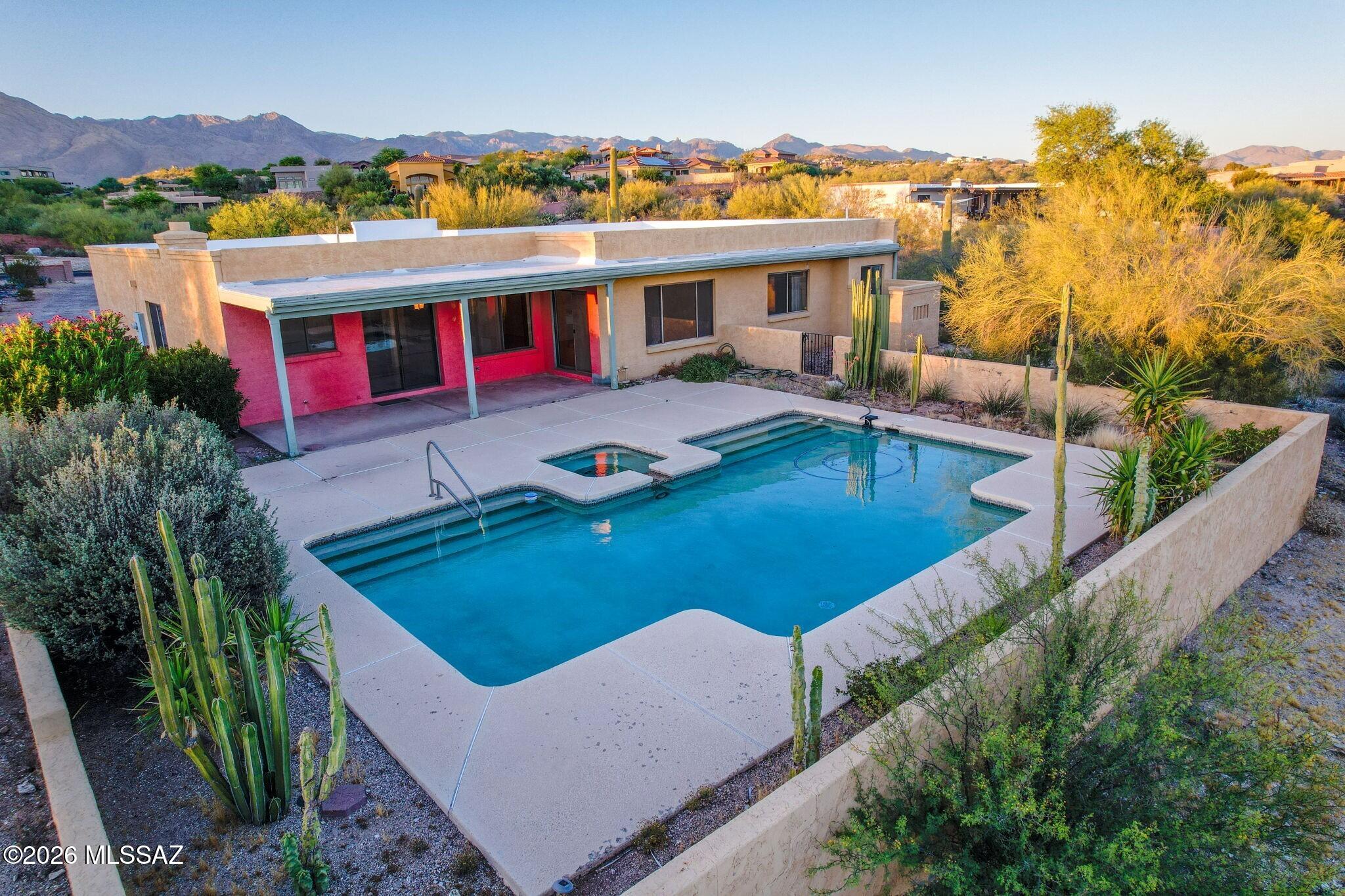 Southwest-style home tucked away on an elevated desert setting in the Tucson Foothills., offering privacy, character, & sweeping city views. Classic territorial architecture, mature saguaros, and a sparkling pool/spa create the feel of a true desert retreat. Inside, expansive living spaces feature oversized picture windows, Saltillo-style tile throughout, and a striking beehive fireplace centerpiece. The home offers a flexible layout ready for personalization, blending timeless Tucson design with opportunity to update and make it your own. Spacious covered patio overlooks the pool and natural desert landscape -- ideal for entertaining or enjoying monsoon sunsets. Rare foothills location with space, views, and authentic Southwestern charm.