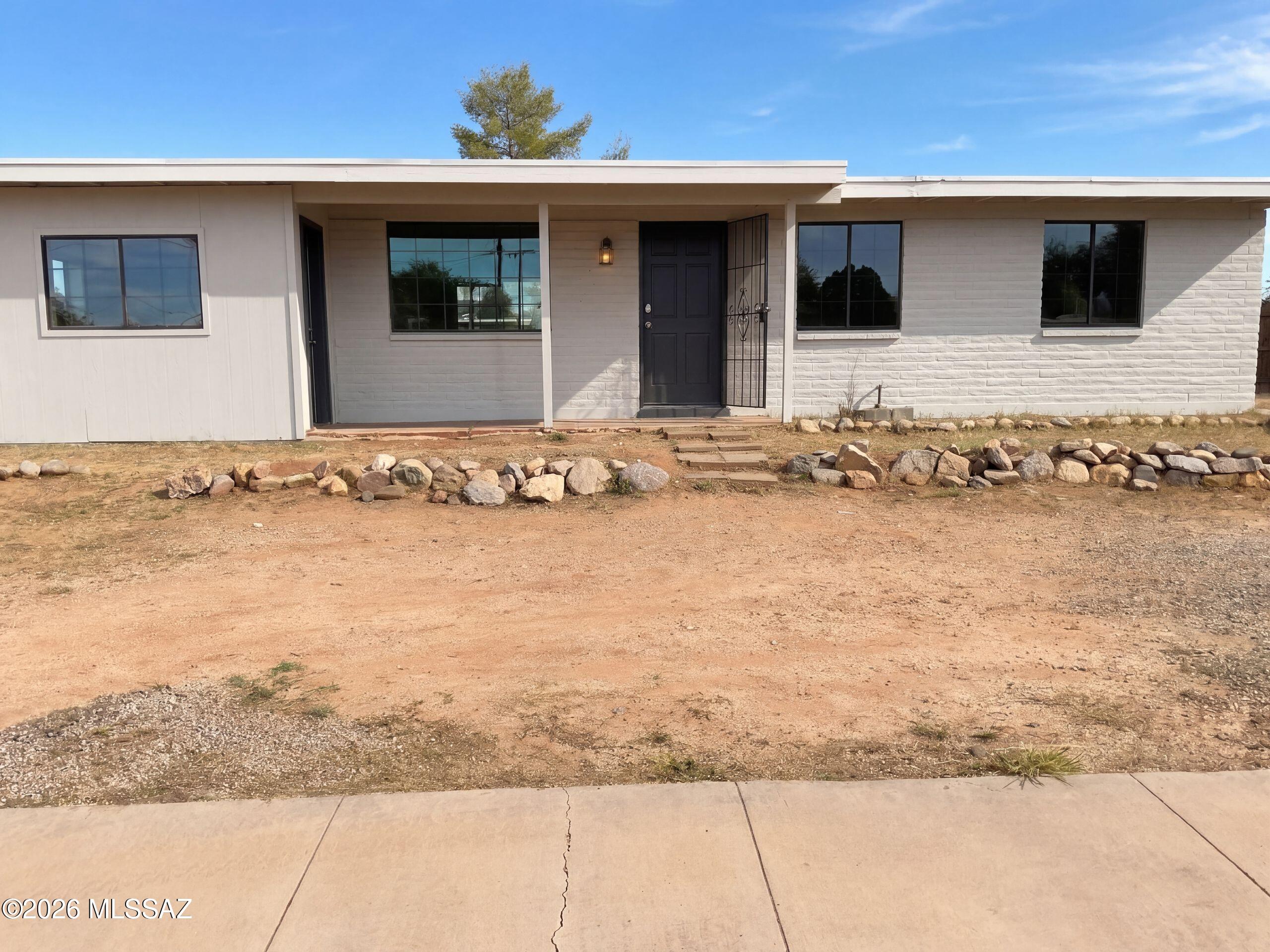 INCREDIBLE BUYER INCENTIVES: $3,000 MORTGAGE CONCESSION. Seller will pay up to $3,000 at closing towards your interest rate buydown if you finance with lender of sellers choice.

4545 S Dogwood Ave is a single-story Tucson home built in 1972 with 1,090 square feet of living area, three bedrooms, and two bathrooms. The kitchen has an extended counter and opens toward the dining area. A sliding door leads from the shared living space to a patio and yard. The bedrooms are arranged off the central living area, while separate bathroom views show the home's practical layout. The front exterior and open yard round out the property. Included 100-Day Home Warranty with buyer activation