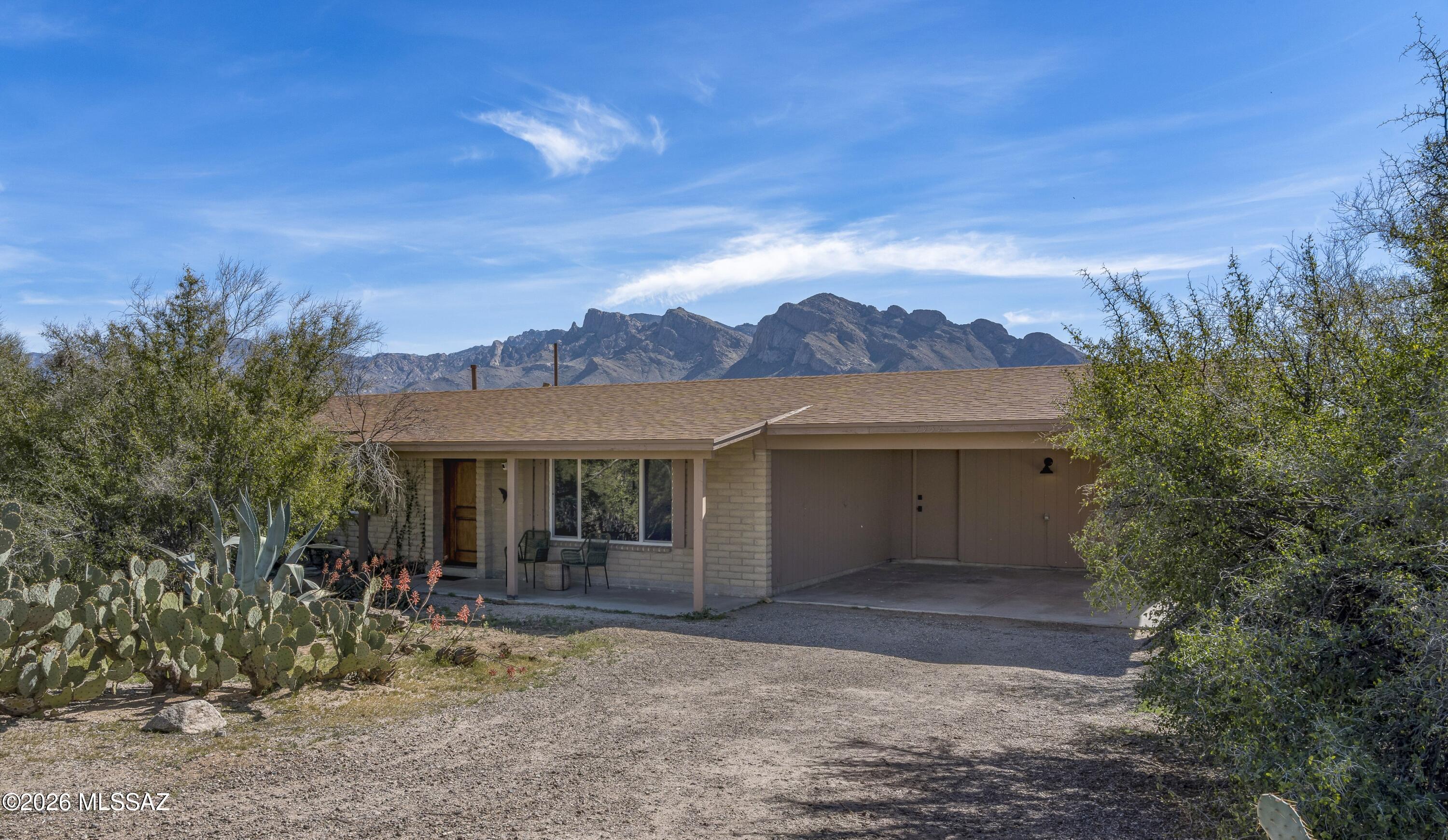Enjoy wide open space & stunning mountain views at this beautifully updated home set on a sprawling .83-acre lot. With no HOA & plenty of room for your RV, boat, trailers & toys, this property offers the flexibility you are looking for. Major recent improvements include a new roof, new windows & newer HVAC for comfort & peace of mind. Inside you'll find Saltillo tile paired w/brand-new carpet, a spacious kitchen w/granite counters, maple cabinetry & SS appliances, plus new, beautifully updated bathrooms. Primary suite offers 2 closets & ensuite bath w/walk-in shower. The large walled backyard offers privacy & endless potential, while the huge laundry room provides bonus space for a home office, gym or hobby area. Room to roam, room to park, and room to live your active Tucson lifestyle.