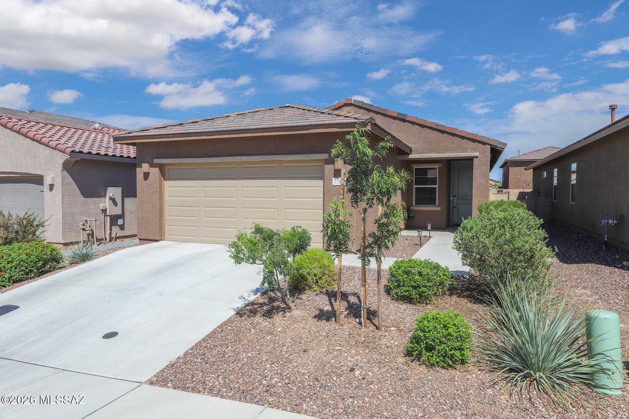 Beautiful newer 3-bedroom + office/playroom home in the popular Estancia community! This bright and open split-bedroom, great room floor plan offers comfortable living with a spacious kitchen featuring stainless steel appliances, pantry, center island with breakfast bar, and plenty of prep space. The private primary suite includes a walk-in closet and in-suite bath with double vanity.  Complete with a R/O water filtration & water softener. Enjoy Estancia's outstanding amenities, including parks, pickleball courts, a community pool, and recreation center. Convenient to Davis-Monthan AFB, the Air National Guard, Tucson International Airport, I-10, shopping, dining, and more.