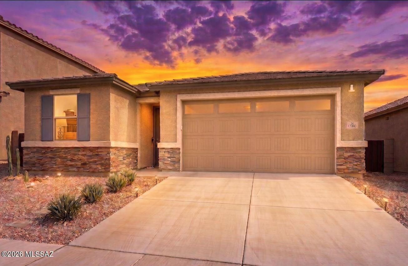 Welcome home to your VA 2.375% (2.42% APR) assumable loan 3 bedroom, 2 bath, 3 car (tandem) garage 2021-built single-story retreat located in the award winning Vail School District. The heart of this home is an inviting kitchen with granite countertops, walk-in pantry and breakfast nook overlooking a spacious great room. The home features three full bedrooms, including a beautiful primary suite with oversized walk-in closet and no carpet. Upgraded tile runs throughout the kitchen and living area. Natural light abounds with an enormous double (four panel) sliding glass door leading to your large covered patio. Dedicated laundry room with both gas and electric connections. Ceiling fans throughout, and 9' ceilings The beautifully landscaped yard is the perfect place to entertain on an Arizona evening, complete with turf for plenty of play and gathering areas on the covered patio. The 3rd bay of the garage is tandem, for either a long vehicle, extra storage, or workout area. Your new home is located in the highly desirable La Estancia community where you will love the great selection of schools available within the sought after Vail School District. La Estancia has direct access to 'The Loop', an interconnected system of more than 135 miles of paved pathways and bike lanes, two community pools, basketball court, pickleball courts, and more than eight beautiful parks. La Estancia is within close proximity to many major employers, including Davis-Monthan AFB, Tucson International Airport, UA Tech Park, Raytheon and Amazon. Come see your gorgeous new home today!