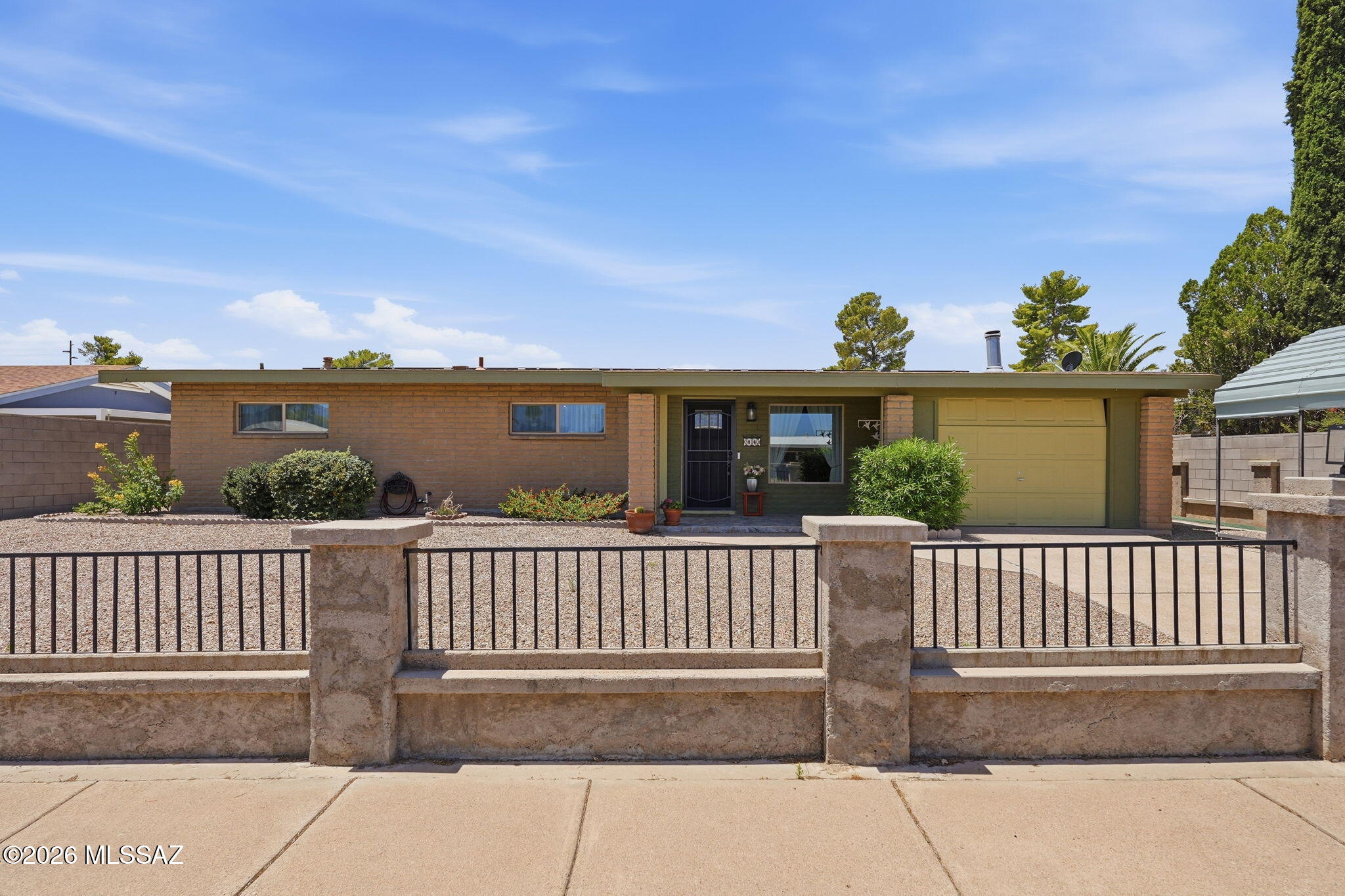 Beautifully maintained 1,528 sq. ft. home (updated from 1256 Sq Ft by Appraiser) offering comfort, flexibility, and thoughtful updates. Originally a 3-bedroom, the floorplan was redesigned to create an expansive primary suite with spacious closet space, a work area, and a remodeled bath featuring dual vanities and a custom tiled walk-in shower. A recently added wall provides added privacy between the bedroom and bath. The cozy family room with fireplace could be converted back to a third bedroom. Enjoy low-maintenance landscaping, an oversized workshop/storage building with room for a side-by-side, and drive-through access to the rear alley. Whether you're looking for room to relax, space to create, or a home that can adapt to your changing needs, this is it!