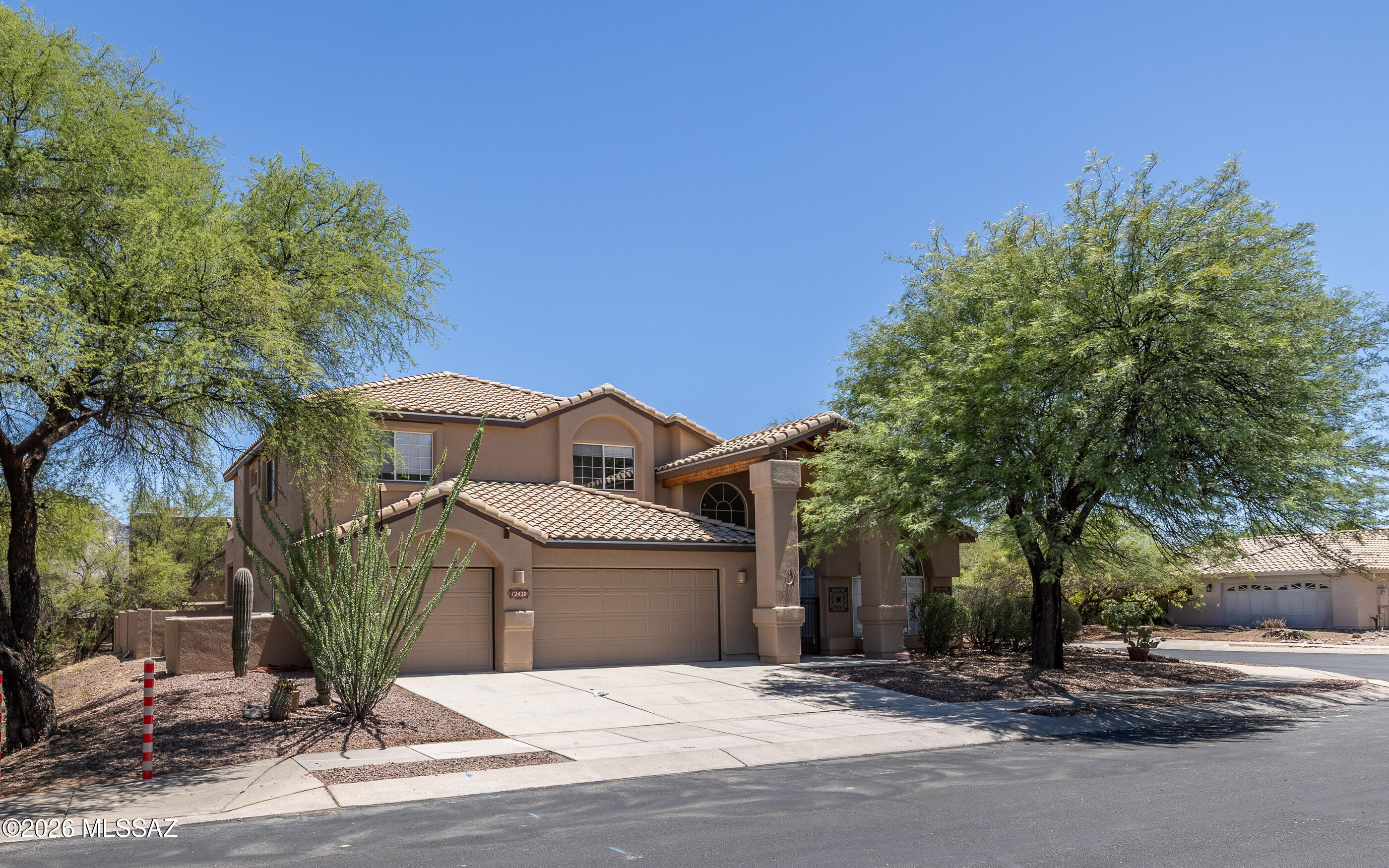 Welcome to Rancho Vistoso, where comfort, space, and stunning desert scenery come together. Situated on a premium private corner lot, this exceptional 5-bedroom, 3.5-bath home offers a spacious open floor plan with soaring vaulted ceilings that create a bright and inviting atmosphere.

Designed for flexibility and convenience, the home features two primary suites, making it ideal for multigenerational living or hosting guests. The warm and inviting beehive fireplace adds character to the main living area, while the upgraded primary bathroom showcases a beautifully remodeled walk-in shower for a luxurious retreat. Step outside to your own backyard oasis, complete with an expansive extended patio, heated pool and spa, and plenty of space for entertaining family and friends. Enjoy breathtaking mountain views from the sundeck off the primary bedroom--the perfect place to relax with your morning coffee or unwind at sunset.

Located just a short distance from the neighborhood park, this home combines privacy, generous living spaces, and resort-style outdoor amenities in one of Rancho Vistoso's most desirable settings. Don't miss this incredible opportunity to enjoy Arizona living at its finest.