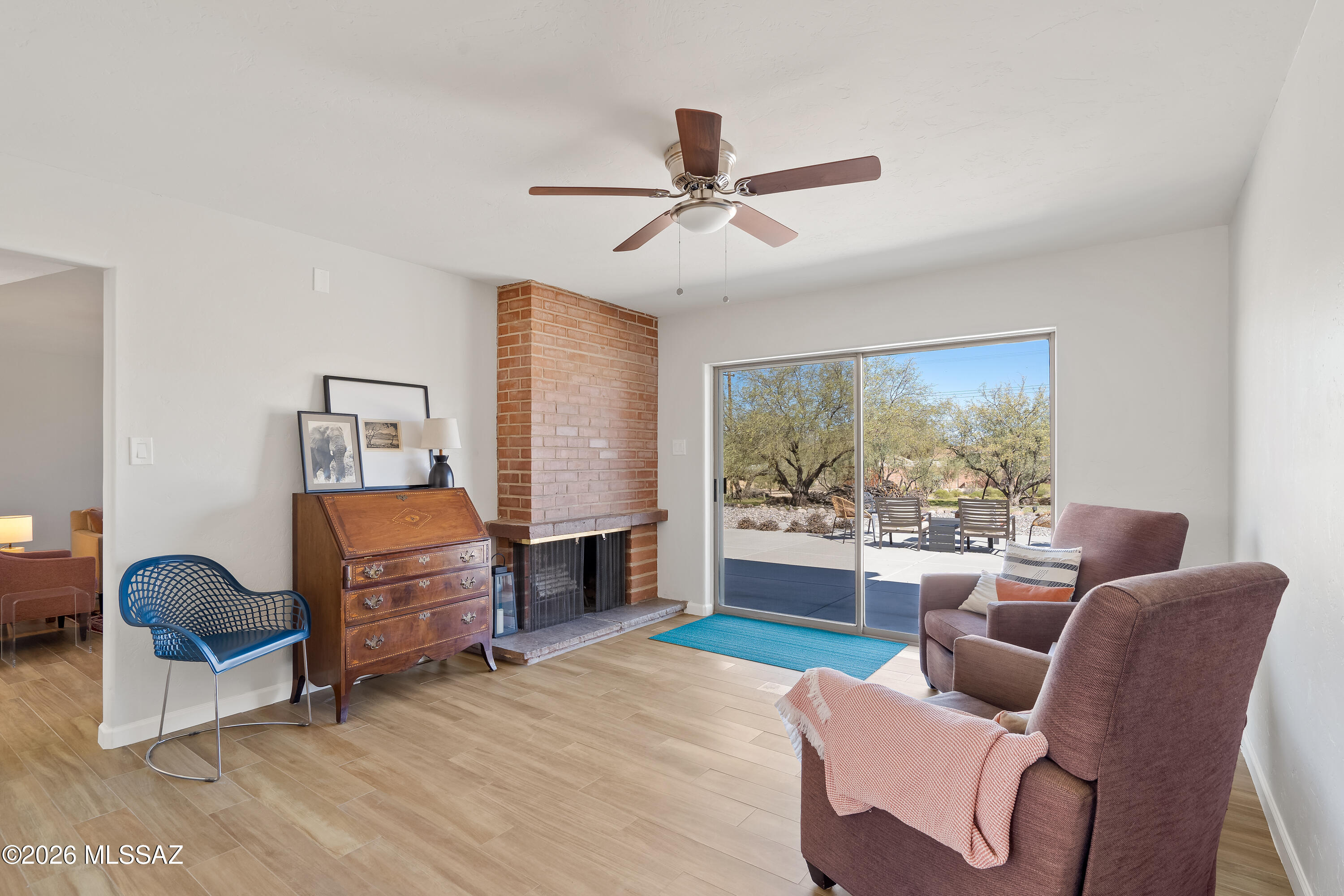 Experience ''room to live'' in this expansive 5BR, 3BA home nestled on a generous .82-acre lot. This home boasts a thoughtful split floorplan that provides privacy and flow, anchored by a 2004 primary suite and garage addition and a top-to-bottom update in 2020. The heart of the home is a light-filled kitchen featuring stainless steel appliances and upgraded induction stove. For cozy evenings, the living and family rooms are seamlessly connected by a double-sided fireplace, Practicality meets luxury with custom Elfa closets, a newer hot water heater ('22), and Tucson Rolling Shutters solar shades. Step outside to the oversized patio to enjoy sweeping mountain views and a massive backyard. Please see attached improvements list. Washer, dryer and refrigerator are included in the sale!!
