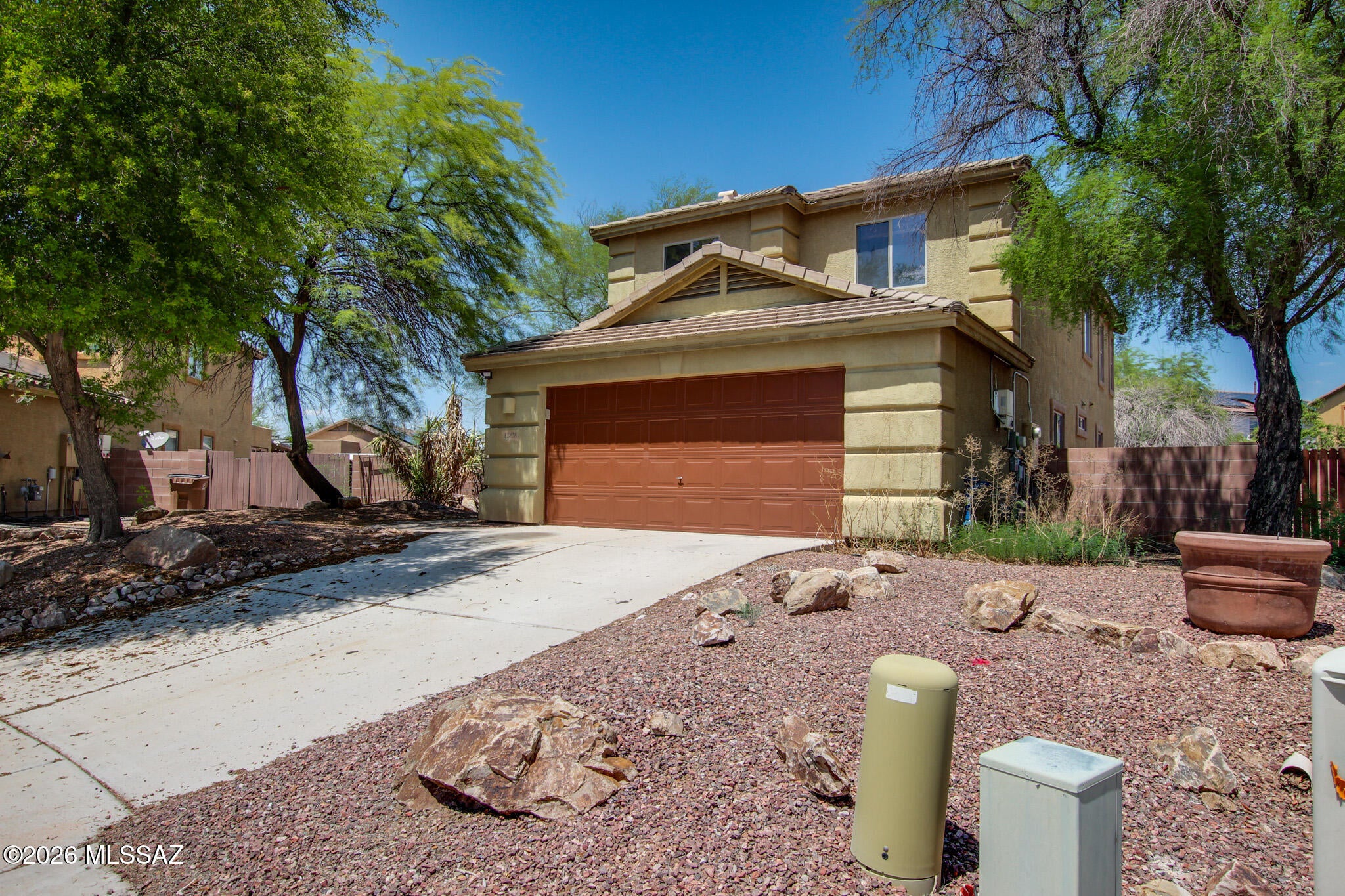 Situated on a quiet cul-de-sac in Marana, this spacious home sits on a generous quarter-acre lot with an expansive backyard offering endless potential. The functional floor plan features an open living and dining area, a kitchen with granite tile countertops and backsplash, white cabinetry, and stainless steel gas appliances. A downstairs bedroom and full bath add flexibility, while the separate laundry room includes the washer and dryer. Upstairs offers a versatile loft, a spacious primary suite with LVP flooring, dual sinks, a walk-in closet, and a tiled tub/shower, plus three additional bedrooms and a full hall bath with dual sinks. Newer A/C, newer water heater, and solar complete the package.
