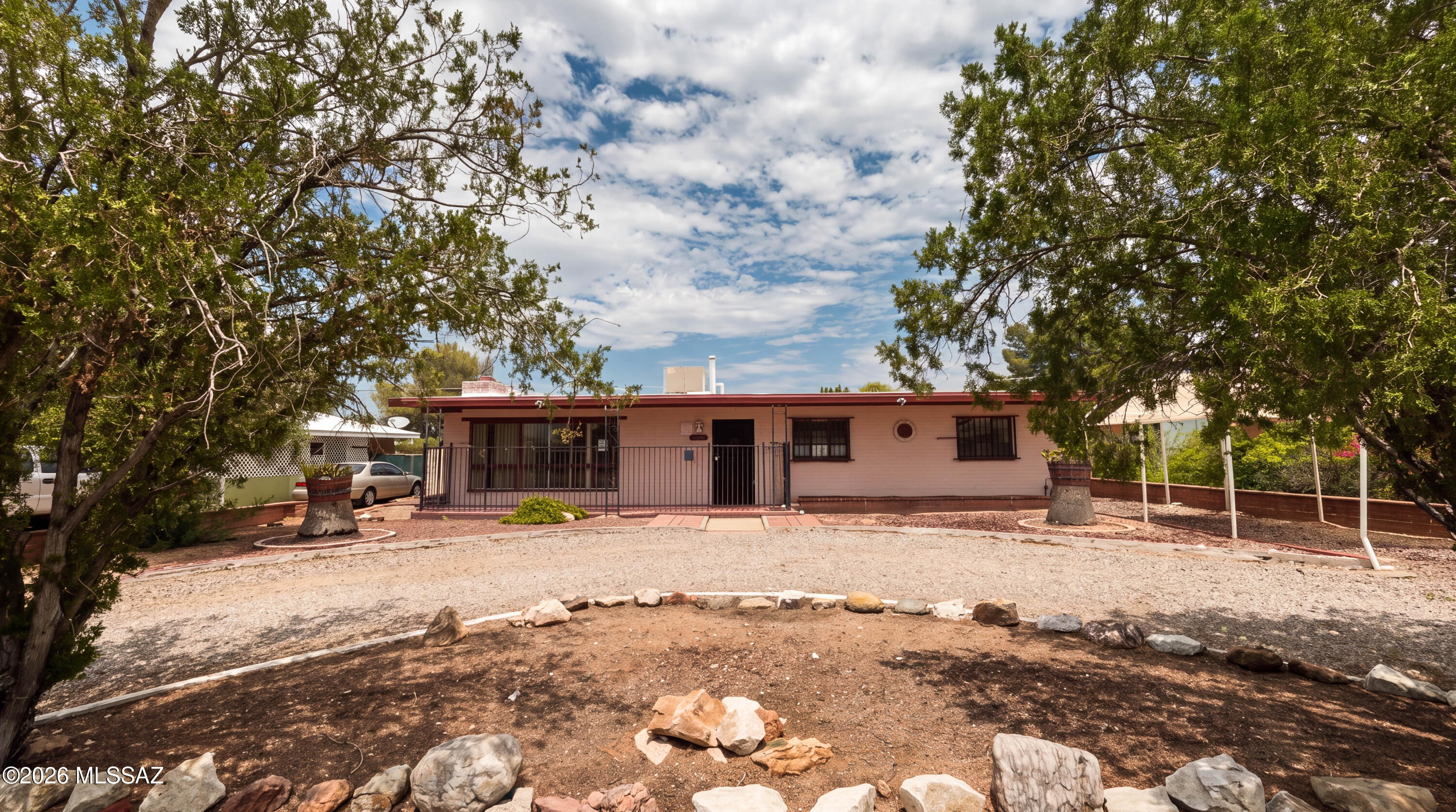 Discover the potential of this charming mid-century brick ranch in central Tucson! This inviting home features an expansive living room with a cozy fireplace, a formal dining room, and two spacious bedrooms, plus a versatile bonus room that can easily serve as a third bedroom, home office, den, or hobby space. Step outside to a generously sized backyard with multiple outbuildings, perfect for a workshop, storage, or creative projects. A circular front driveway adds curb appeal and convenient parking. Bring your vision and personal touches to make this classic home truly your own!    CASH OF HARD MONEY OFFERS ONLY!