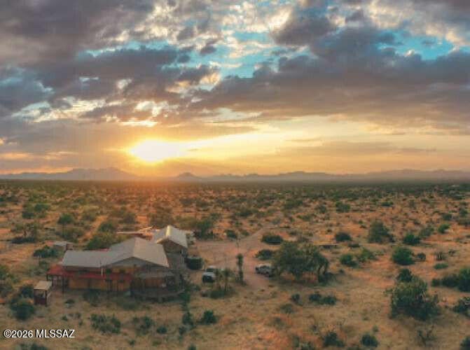 Artful sustainable, off-grid strawbale home has R-65 walls, 7 kW solar, 11,000 gallons water storage, 1,500 sf utility building w greenhouse potential, bathroom, harvest prep area, workshop, storage.
House has open design of natural plaster and traditional Mexican craft decor throughout, w nickle-lined copper tub and copper sinks, 3 bay windows, bamboo and decorative pressed-tin ceilings, arched doorways, new fridge, antique stove/oven, minisplit, 2 ACs, almost fully furnished (unwanted furniture can be removed).

Three patios w beautiful views of Altar Valley to north (nighttime lights!) and Sierrita Mountains from private patio on south.

Mesquite-post patio wraps around house front and side, with no-maintenance floor.

3 miles to cafe market. 8 miles to Ace. 20 miles to town.