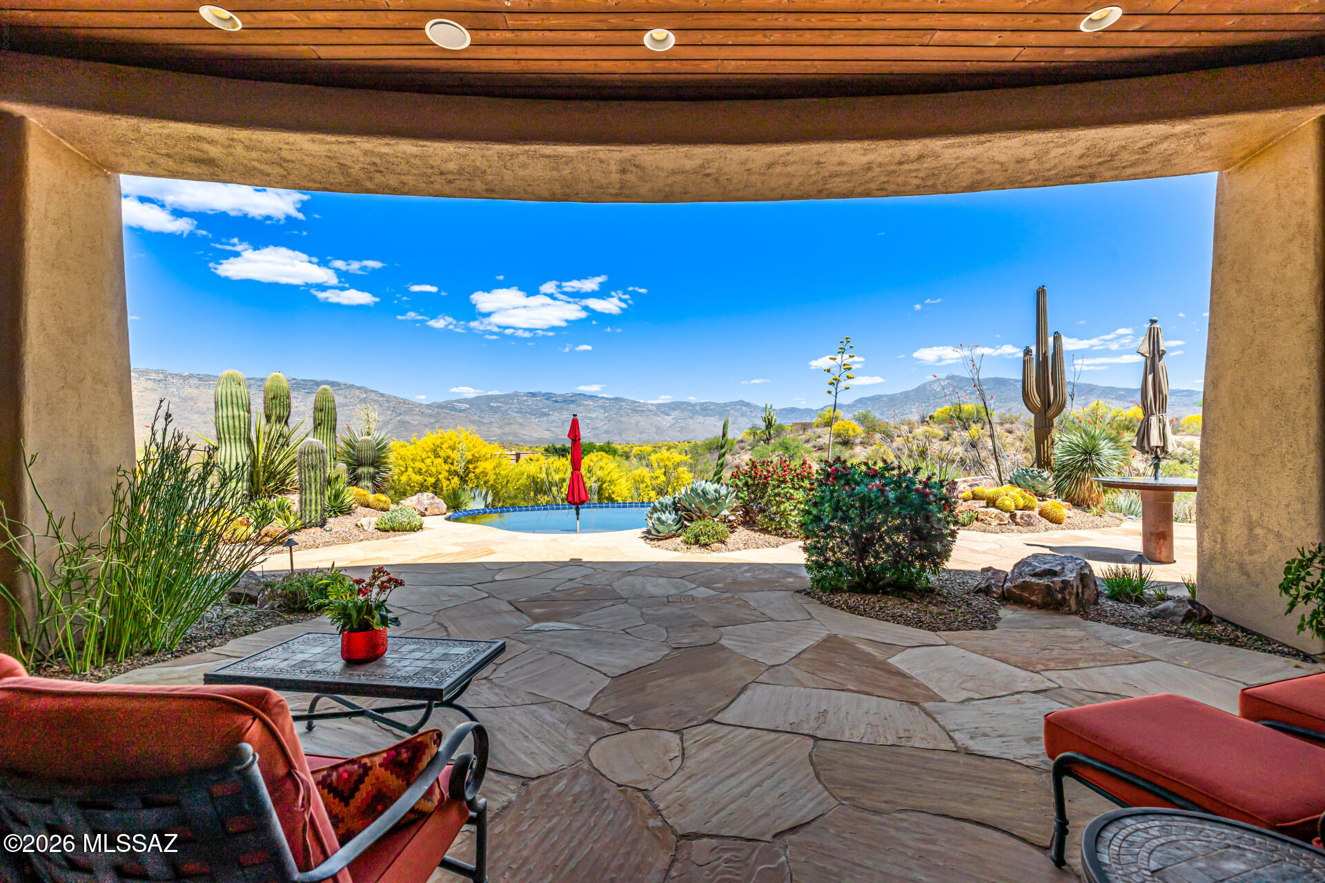 Santa Fe-style home on a sprawling 1-acre lot at a gated community! Natural desert landscaping, circular driveway, & 3-car garage greet you upon arrival. The double ironwork doors lead into an inviting foyer to find timeless architectural details, such as arched doorways, tray ceilings, recessed lighting, surround sound speakers, & a fire sprinkler system. The welcoming great room features a stunning stone-accented fireplace & breathtaking mountain views! Do not miss the formal dining room, powder room, & Jack & Jill bathroom for convenience! Well-appointed kitchen boasts SS appliances, wood cabinetry w/crown molding, granite counters, center island, breakfast bar, & walk-in pantry. appreciate. The kitchen is equipped with Bosch appliances and a Bertazzoni Italian stove top range, custom painted tile backsplash, two islands with seating and a beverage fridge. The exquisite Primary suite offers a relaxing sitting area with access to your private patio and sweeping views of the Rincon valley, the primary bath has dual vanities and his and her walk in closets. Oversized garage with epoxy flooring. Knife edge, pebble tec pool that is solar heated. See list of upgrades and building specs for more information.