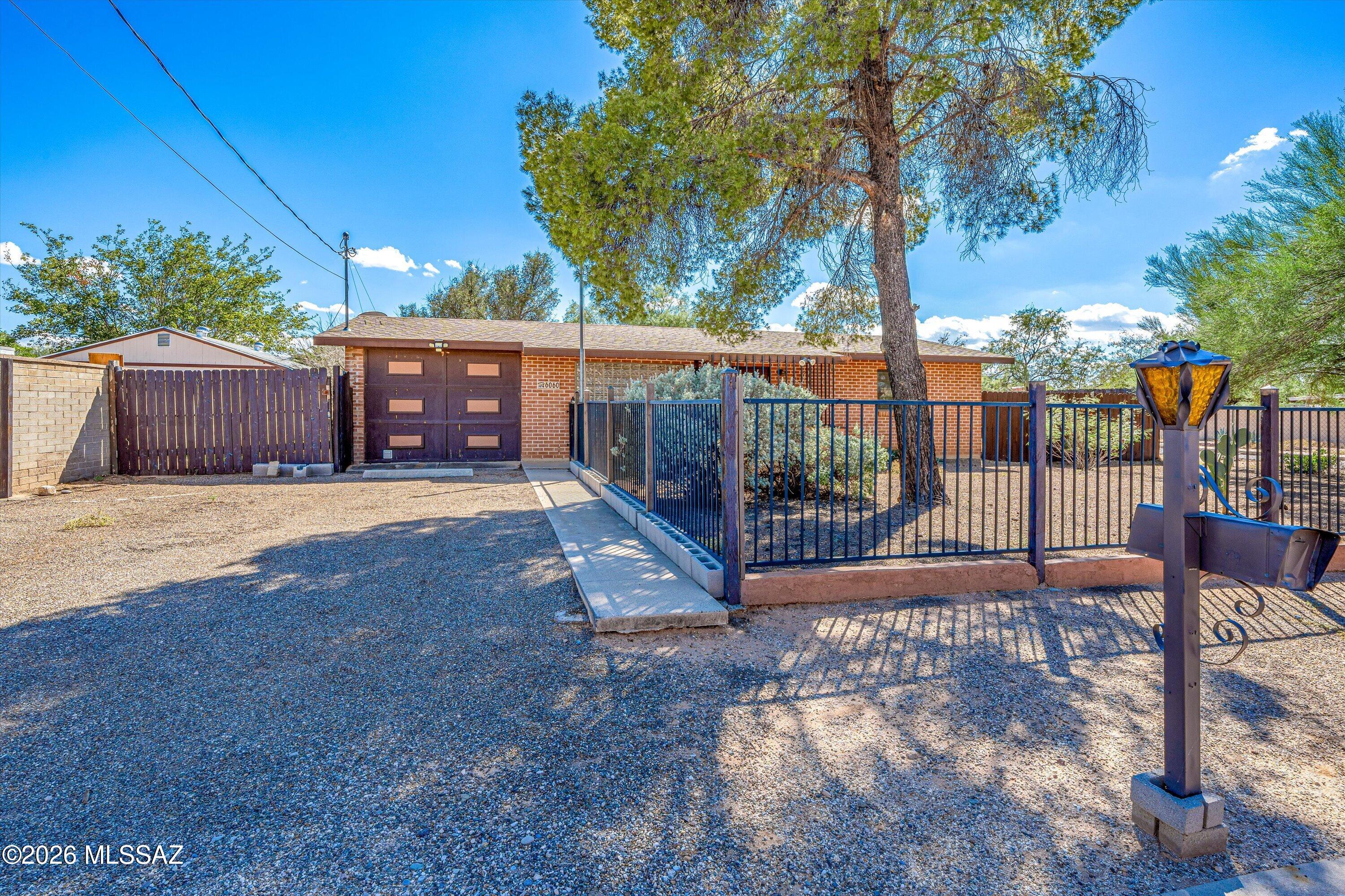 Welcome to this charming 3 bed, 2 full bath home with premium oversized lot. Featuring a desirable split-bedroom floor plan. Take advantage of the oversized lot by making it your private sanctuary, building a pool or by using the new Tucson code on ADU's, Casitas & guest houses. The possibilities are endless! Inside this beautiful home you will find slate tile flooring throughout, a sparkling kitchen with stainless steel appliances, gas oven/stove & spacious bedrooms. The split bedroom plan with primary suite on one side & additional bedrooms on the other make it extremely functional. The primary suite features plenty of space, and a gorgeous on-suite with custom tile surround shower/tub combo. Step outside and enjoy the large covered patio and wonderful yard space. NEW WASHER & DRYER!
