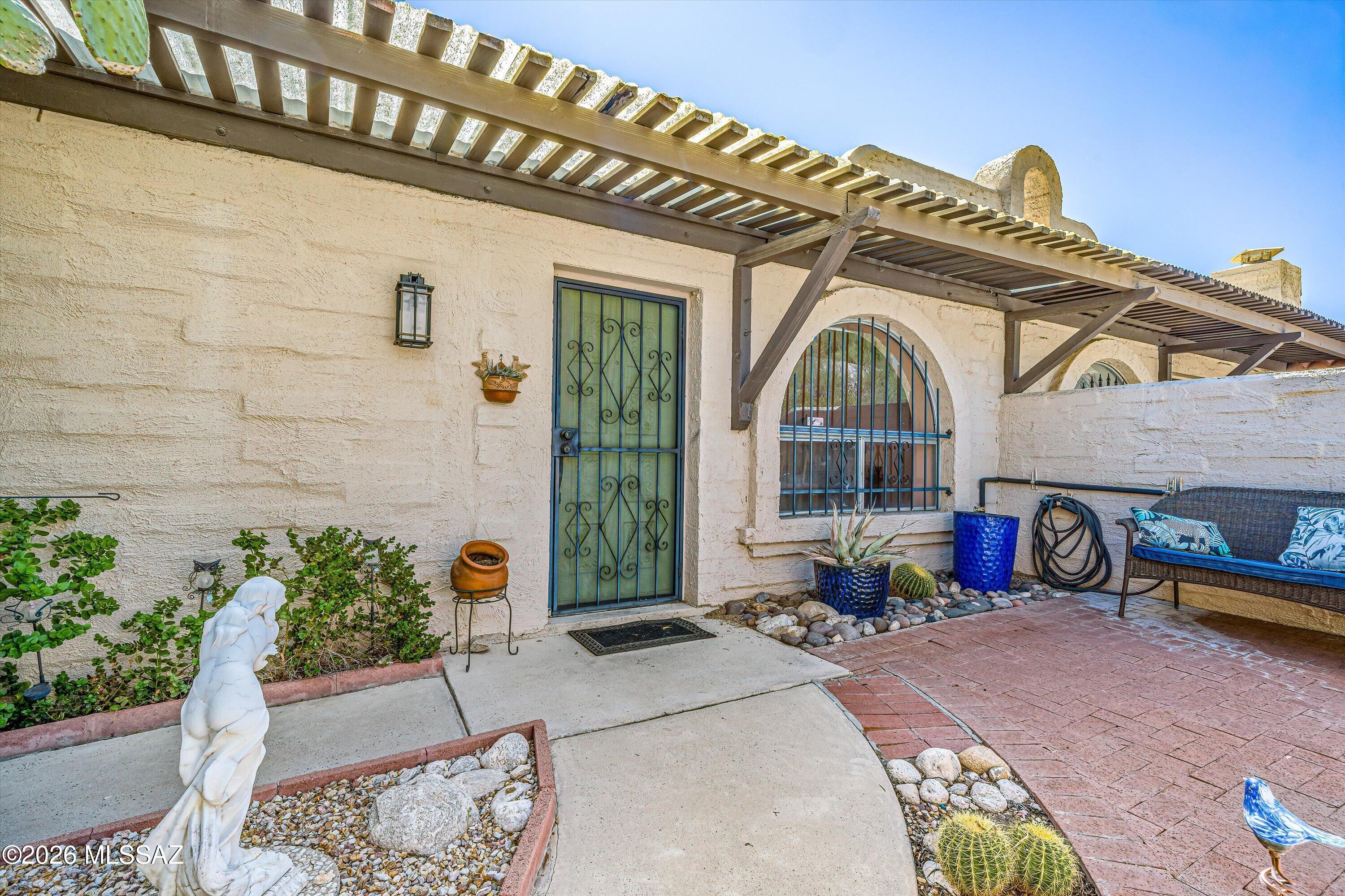 Tucked into the back of the Pueblo Villas community for maximum privacy, this 2 bed, 2 bath townhome near Oracle & River delivers effortless Southwest charm. Easy-care tile runs throughout, and generous natural light fills the open living space, anchored by a classic beehive fireplace that adds warmth and character. Step out back to your own serene patio retreat, complete with desert landscaping and a citrus tree, a shaded escape for morning coffee or evening unwinding. The community pool is just steps away for hot Tucson days. With quick access to River Road and Oracle, you're minutes from shopping, dining, and the Rillito River path. Low-maintenance living in a quiet, private setting -- perfect for first-time buyers or anyone looking to simplify without sacrificing style.