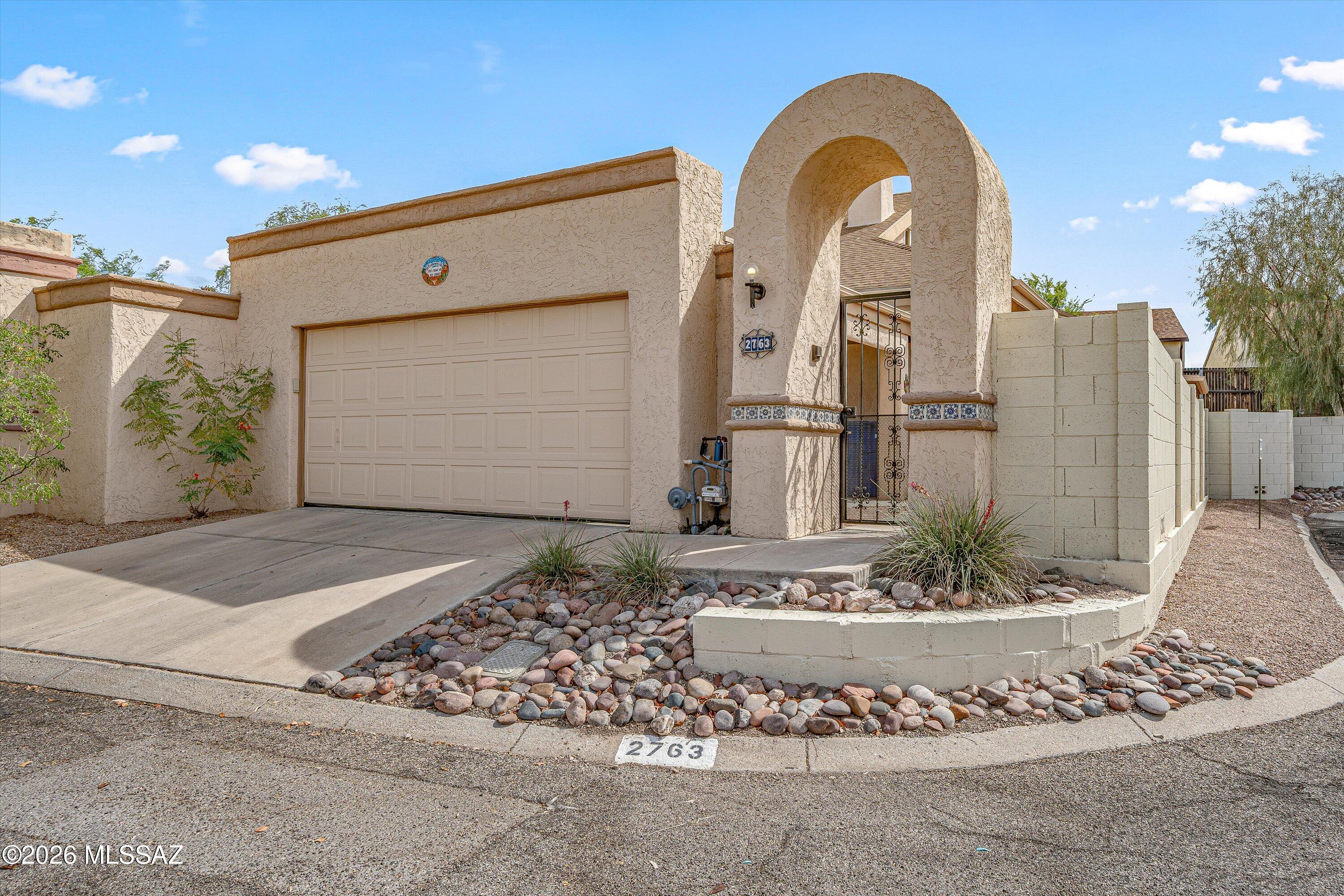 What a great location for this charming & well maintained 3 bedroom home located in the quiet west-side community of Saddlewood Villas. The inviting courtyard welcomes you into the home's spacious great room with vaulted ceilings, filled with natural light & a wood-burning fireplace with stunning quartz surround. The chef in the family will love the beautifully redesigned custom kitchen, featuring hickory cabinetry, an abundance of cabinet storage & quartz countertops. Two spacious guest bedrooms downstairs with an updated full bath. Upstairs you will find your primary bedroom retreat, with an updated bathroom, walk in closet & slider closet as well as additional attic storage. The backyard sanctuary provides privacy with a covered patio to enjoy the outdoors & barbecues. No poly pipe! Enjoy the large community pool and spa during the summer months. This prime location is only 10 minutes from the freeway, close to downtown, U of A and has many outdoor trails for biking & hiking just minutes away.  Updates include energy efficient triple paned windows, Bali blind covers, New exterior paint 2023, Interior bedrooms & stairwell painted 4/25, tankless water heater in 11/25. Please see attached list of improvements and features. HOA covers community landscape, pool/spa, trash and private street maintenance