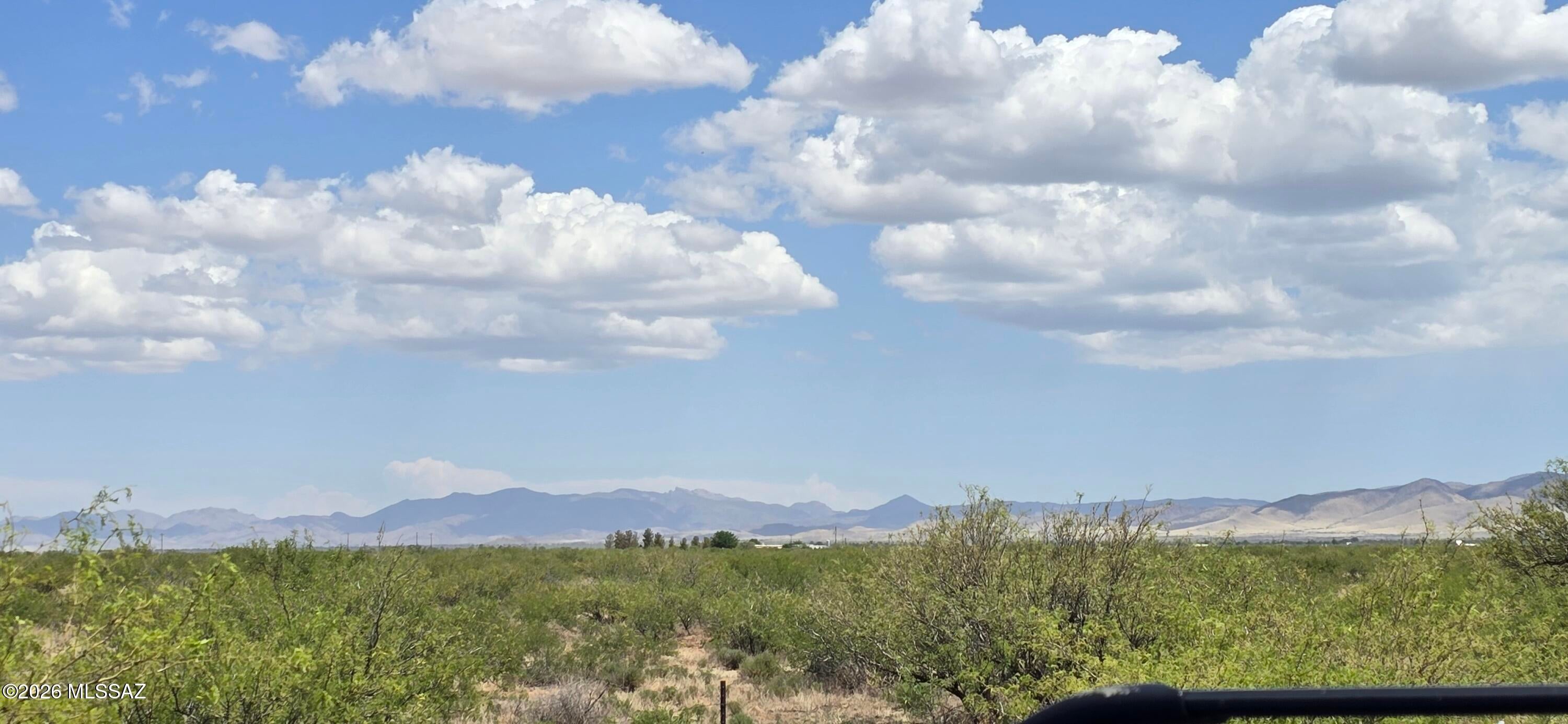Rural living on 8 wide-open acres with outstanding 360° views across the Sulphur Springs Valley. Zoned RU-4, allowing manufactured homes, tiny houses, or site-built construction with no HOA restrictions. An owner-builder permit is available, offering exceptional freedom to start your vision. Electric and phone are approximately 60 ft from the property line. The land is flat, usable, and partially fenced along the front and east side. Enjoy a mild year-round climate and endless horizons in every direction.