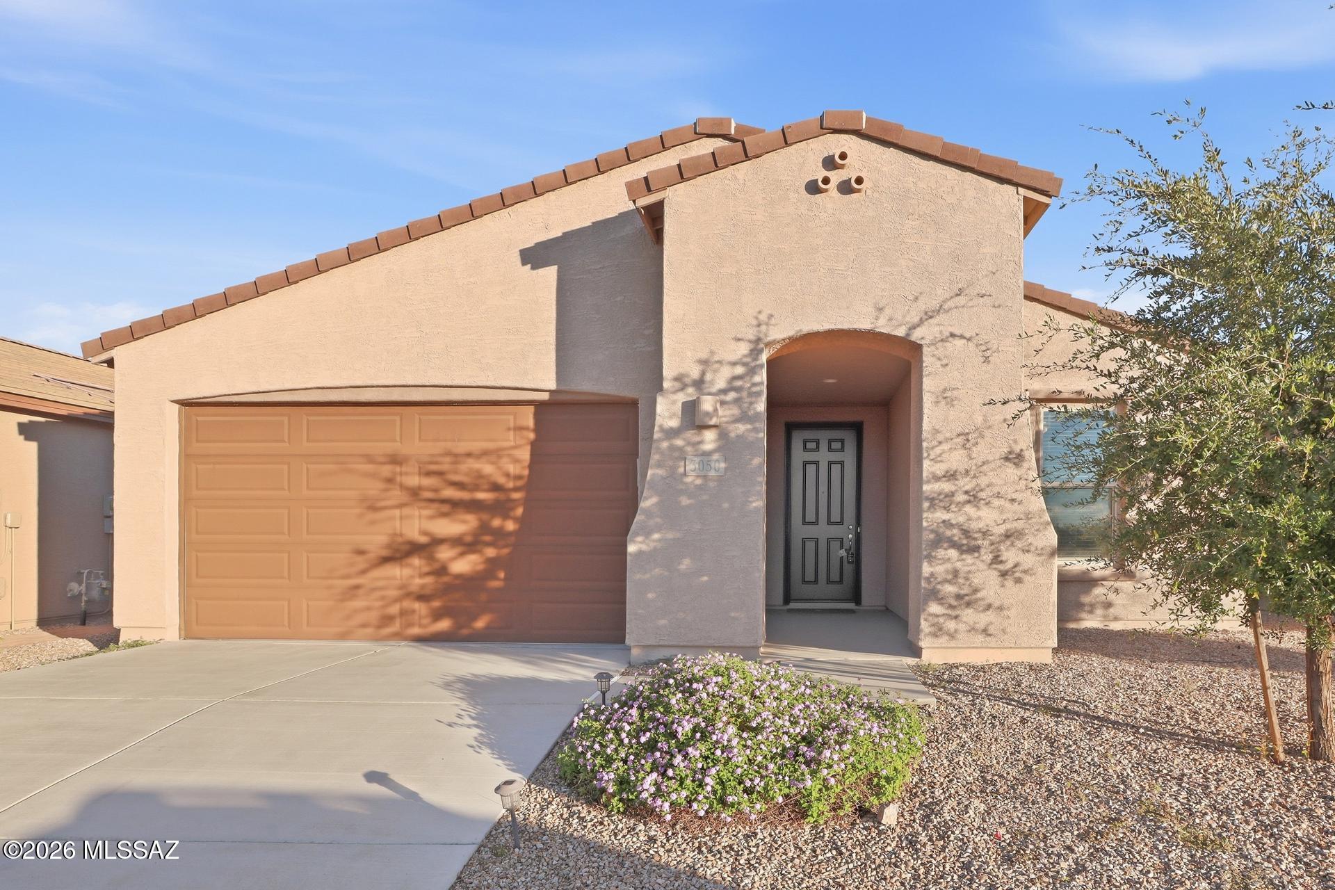 Welcome to 3050 W Willow Moon Trail! This inviting home features a spacious, modern kitchen with white cabinetry, quartz countertops, stainless steel appliances, and an oversized island perfect for meal prep and entertaining. Wood-look flooring adds warmth to the main living areas, while the bedrooms offer comfortable carpeting, ceiling fans, and ample natural light. The stucco exterior, covered entry, and low-maintenance desert landscaping provide great curb appeal. A wonderful opportunity to enjoy comfortable living in a thoughtfully designed home!