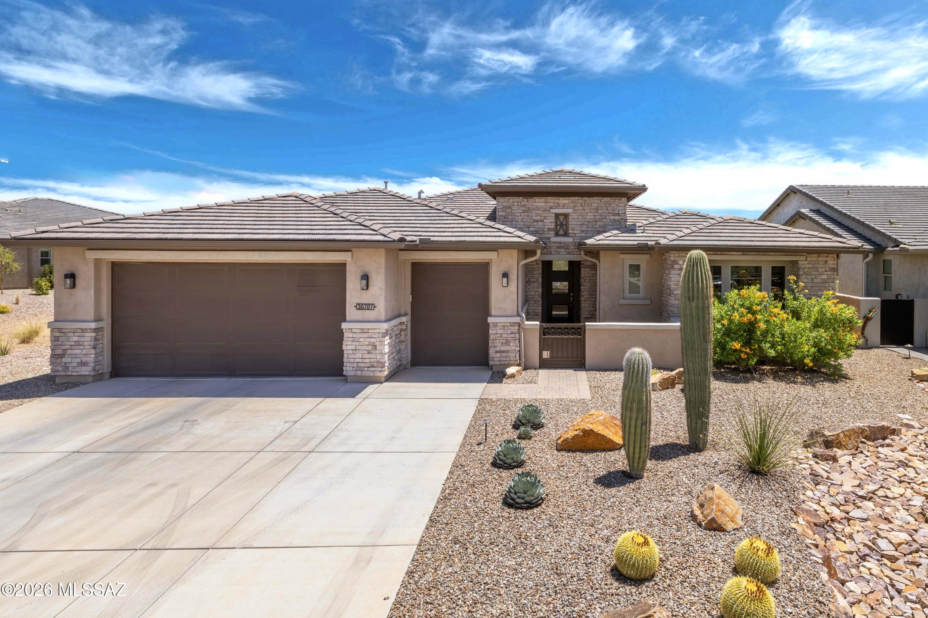 Welcome to resort-style living with the ultimate in privacy and upgrades at SaddleBrooke Ranch. This Tesoro floor plan has been extensively upgraded and expanded throughout -- every room reflects intentional design and premium craftsmanship.
The kitchen truly impresses: a Sub-Zero 42'' refrigerator, granite countertops, induction cooktop, and a bumped-out dining area flow seamlessly into a butler's pantry with custom adjustable built-ins and abundant storage. Cabinets with extra drawers, upgraded trim, and premium finishes round out the space. The extended primary suite offers a private retreat with a spa-like walk-in shower, linen cabinet, and a custom built-in closet. The guest bedroom is also extended, features custom built-in closet storage, and a full bath with tub. The den -- extended 3 feet and complete with a closet and custom built-ins -- functions as a true third bedroom or generous home office.
The oversized garage with a 4-foot extension features epoxy floors, custom wood cabinets, a sink, and a whole-home water filtration system -- plus a driveway extended 5 feet for extra parking. All appliances, including Maytag washer and gas dryer, convey.
Outside, your east-facing backyard backs directly to a vast arroyo, delivering unmatched privacy and the peaceful sounds of the Sonoran Desert. Stucco and iron fencing (with snake screen) frames mountain views to the right, while landscaped common areas on two sides leave you with only one direct neighbor. Watch for coyotes, deer, javelina, and hawks from your covered travertine patio -- a luxury upgrade that speaks for itself.
This is not your average Tesoro. With tile and LVP throughout, every room thoughtfully expanded, and a lifestyle-first lot, 30707 S Blue Granite Ln is the one buyers will remember.
