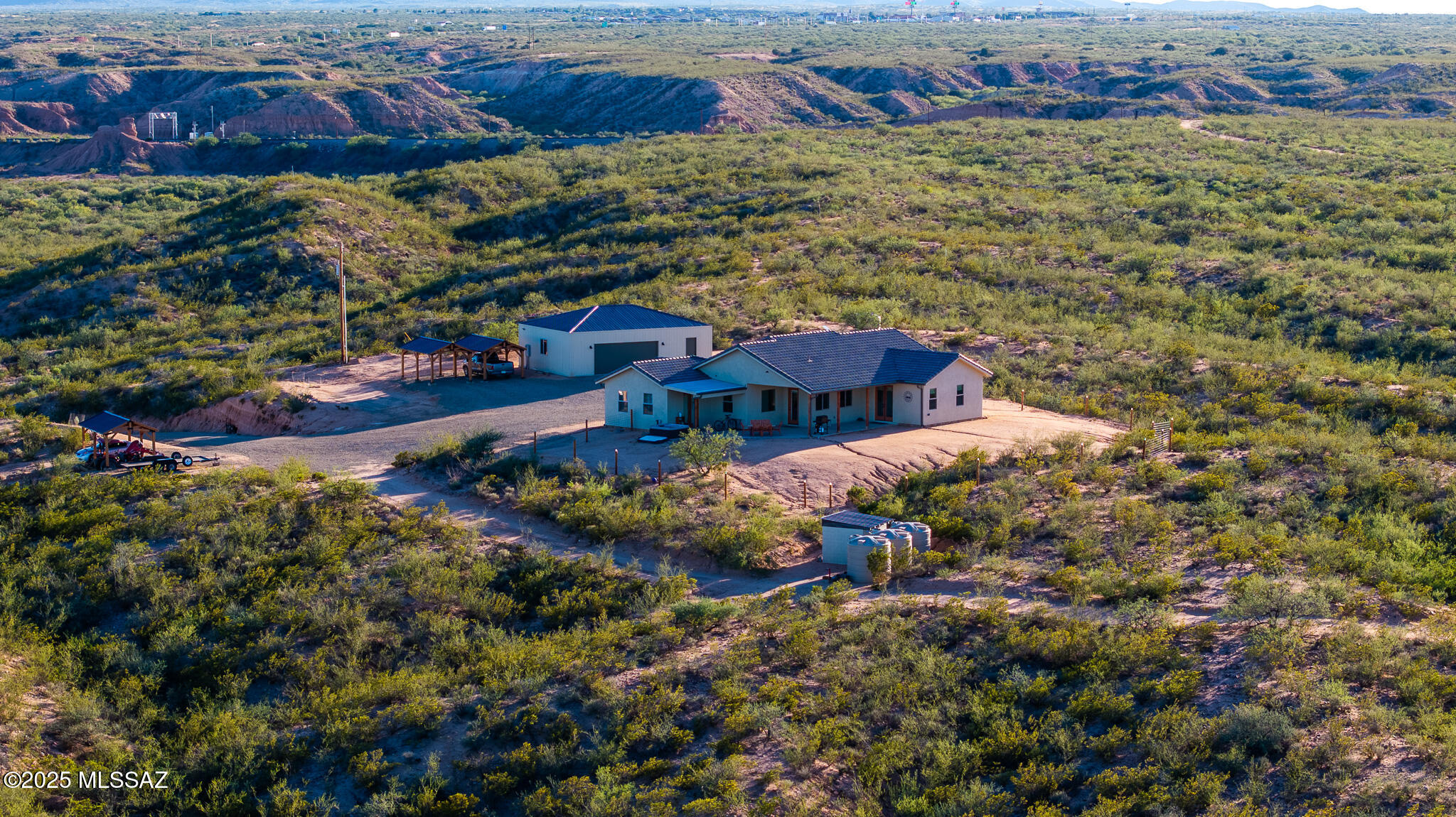 Truly loved steel construction home on 30 acres with unmatched panoramic views + Incredible sunrises AND sunsets! Spray foam insulation keeps the outside at bay while you enjoy your chef's kitchen complete with granite counters, a 48'' gas range and tons of storage. Oversized second bedroom gives you the flexibility for a dual master set-up, a large office space, or an additional living area. A detached, insulated and air conditioned 30x40 shop includes a one bedroom/bath guest quarters. 3 beautiful, wood and steel carports provide shade for cars, toys, equipment, or critters. Add sides and voila...it's a stable! Zoned RU4- Cover the hillsides with vineyards or orchards. Private well is solar powered. 6,000g holding tanks. ENVISION YOUR DREAMS! Call TODAY! This home is a must see!