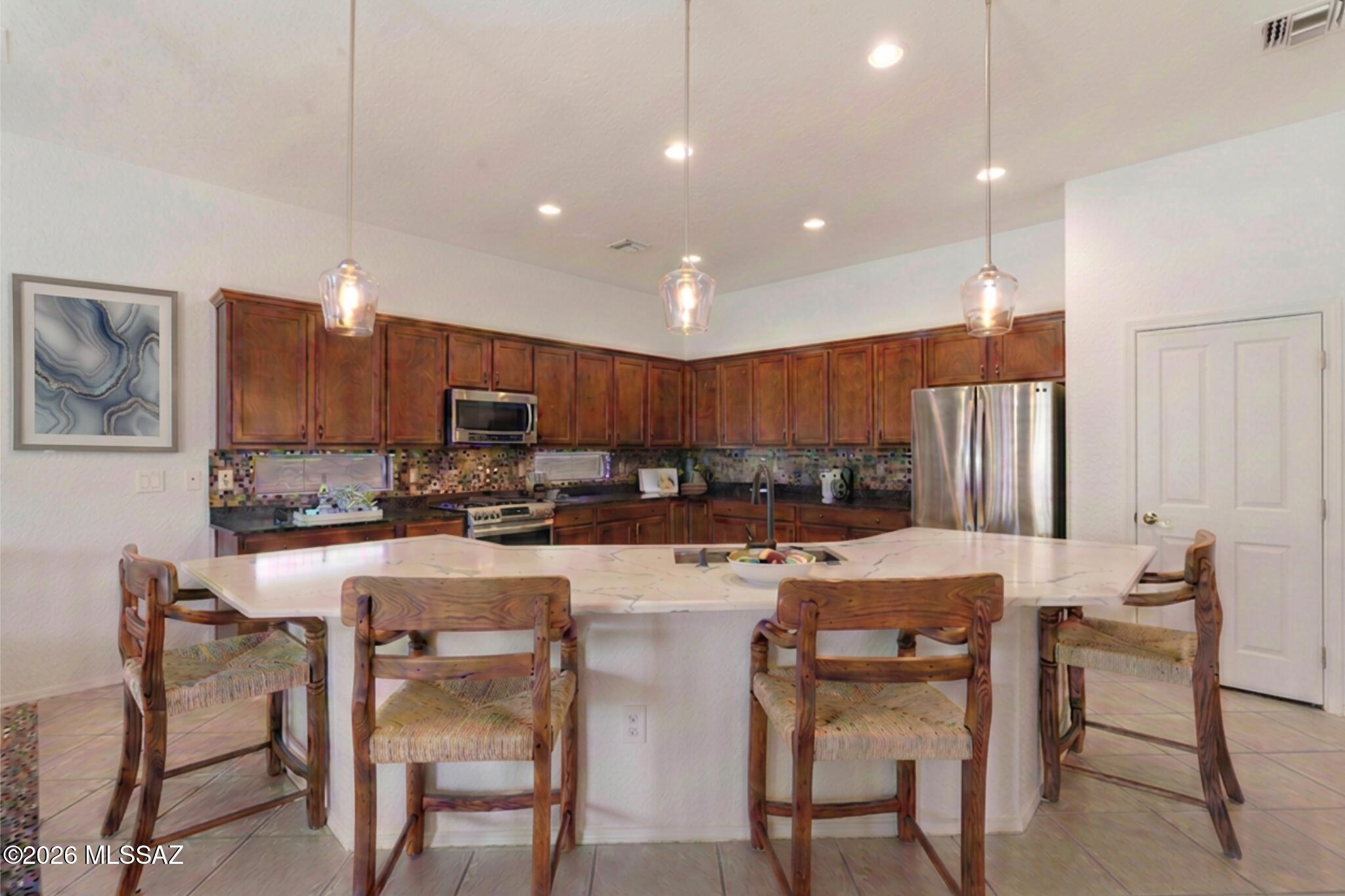 Incredible Opportunity in the GATED Preserve of Dove Mountain - Immaculate gem on a quiet cul-de-sac. The open-concept layout stuns with 12-ft ceilings, custom flooring, surround sound, and a grand great room anchored by a gas fireplace. Gourmet kitchen impresses & massive quartz island, stainless gas appliances, mosaic backsplash, solid wood cabinets, and a large pantry. The main retreat offers backyard access, dual vanities, soaking tub, and a walk-in closet. Step outside to a serene desert oasis with COMPLETE PRIVACY. 3-car tandem garage, Milgard windows with lifetime warranty, new water heater, and washer/dryer included. Minutes from fine dining, shopping, the Ritz-Carlton, and the legendary Jack Nicklaus 27-hole golf course. Community parks, tennis courts & walking paths. Zoned HVAC! complete the lifestyle. This one is truly special.