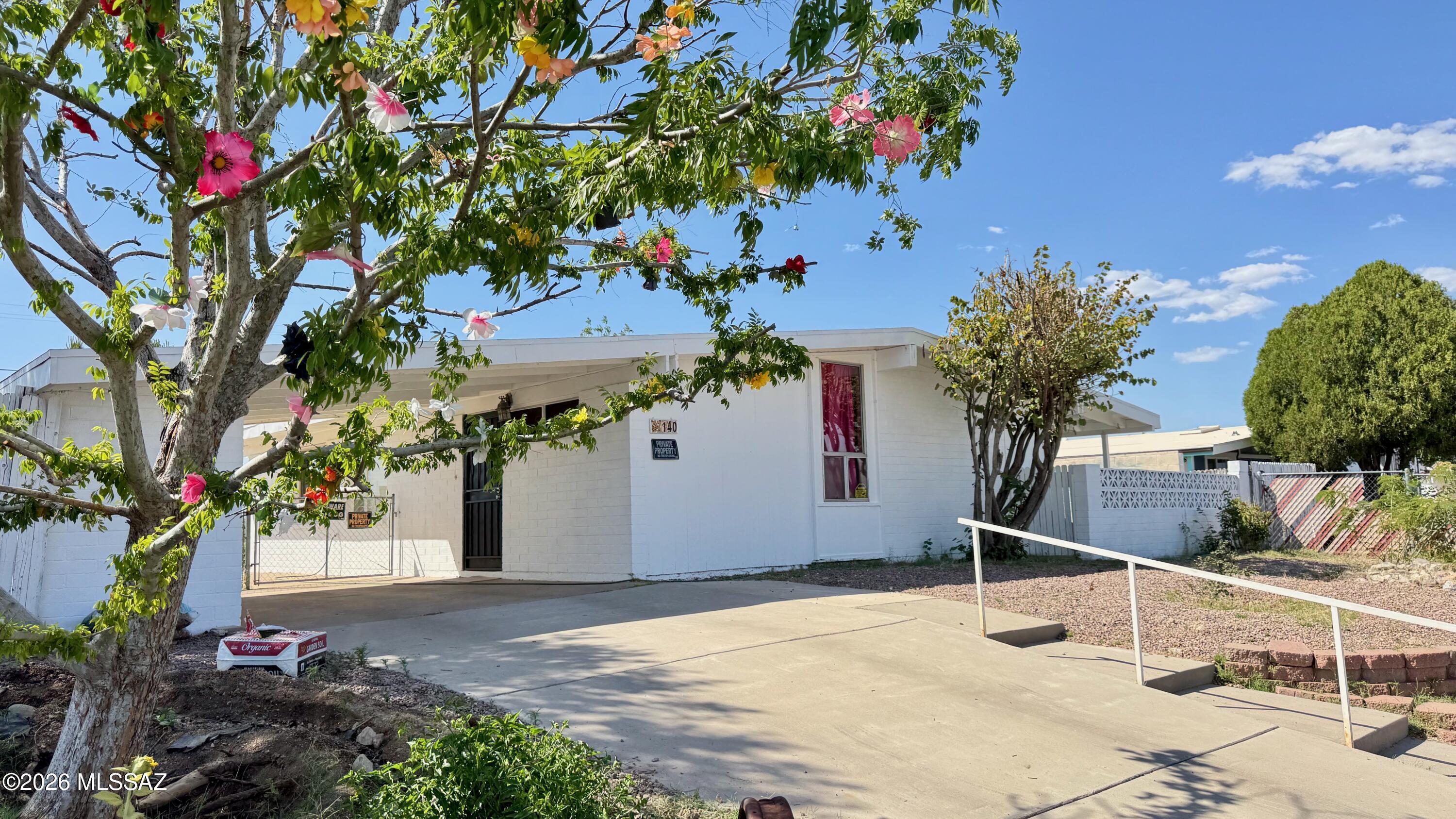 This home is situated on the Western most boundary of the community overlooking open space area with a nice sized wash and with views of Campo Bonito and the best sunsets in the West! The backyard has an abundance of plants with birds galore that come and enjoy the yard. 3 bedrooms and 1 bathroom, this mid century miner community was once bustling and now is sleepy little town just 30 minutes north of Oro Valley/ Catalina. The kitchen has a mix of the old world and new with some metal cabinetry and some wood. Gas Stove for even cooking and even a built in stone BBQ outside on the North side. Double drive in gate in back, 1 car carport. Owner has freshly painted the inside and installed new carpet in 2 of the bedrooms. 2 Storage rooms! Newer AC with Smart Thermostat. Well Maintained!