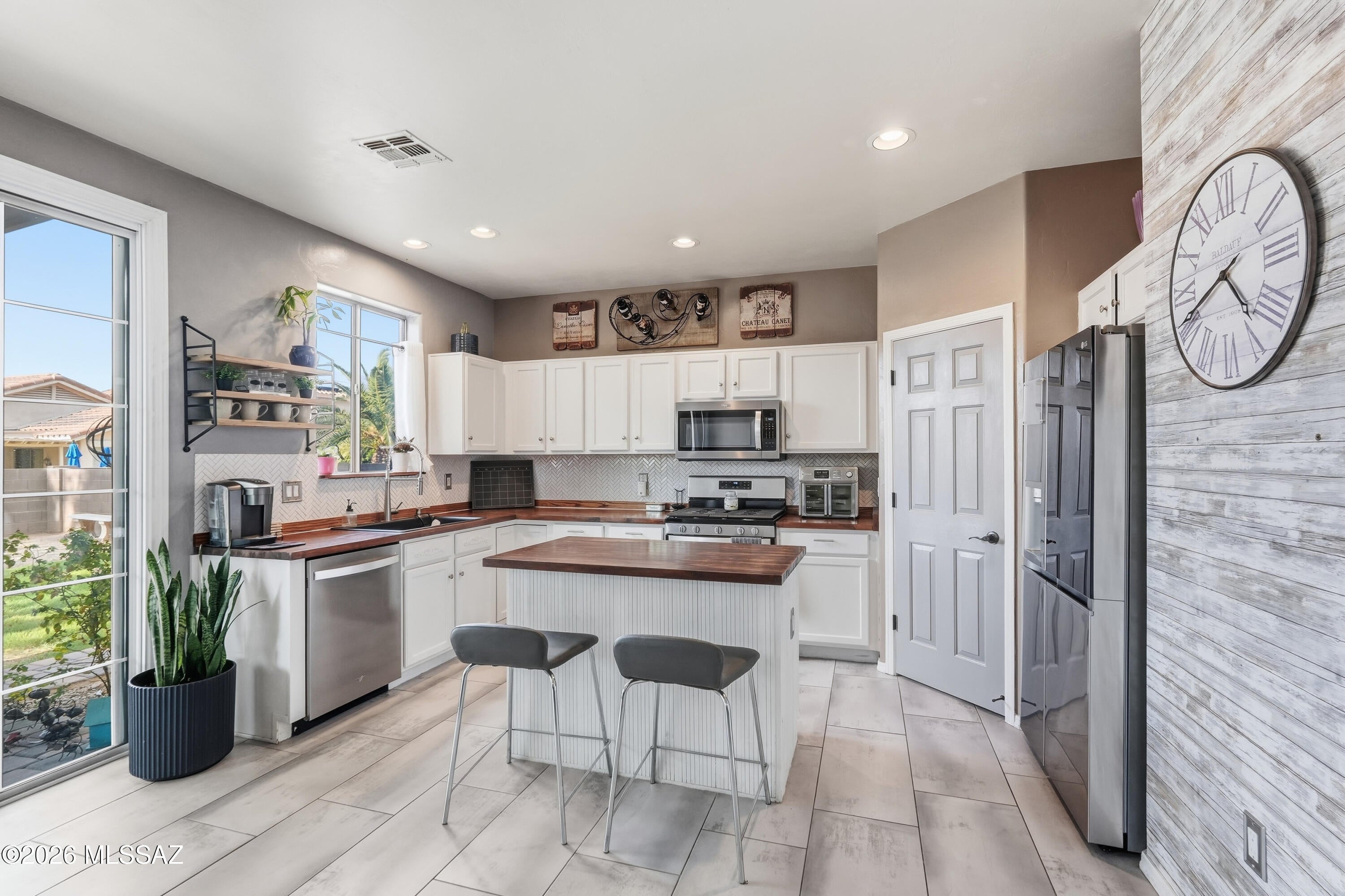 Updated, inviting, and full of flexible living space, this Rancho Sahuarita home offers a layout that feels both comfortable and unique. Step inside to a dramatic two-story entry with a spacious living room, room for a formal dining area, and additional flex space accented by a cozy modern fireplace that adds warmth, style, and character.
The updated kitchen opens to a generous family room, creating an easy everyday gathering space with plenty of room to spread out. A beautifully updated half bath and convenient main-floor laundry room complete the first level.
Upstairs, the designer staircase leads to a versatile loft that works perfectly as a home office, playroom, homework area, or second living space. The primary suite features a double-door entrance along with a special bonus room just off the bedroom--ideal for a quiet reading nook, workout space, nursery, or simply a peaceful place to unwind at the end of the day or start your morning. Two additional bedrooms and a full bathroom complete the upstairs.
Thoughtful updates throughout make this home truly move-in ready, while a new A/C unit provides added peace of mind. Exterior solar screens help with Arizona heat and sun exposure, and mature landscaping gives the property an established feel that can be hard to find with nearby new construction.
Located in Rancho Sahuarita with access to community pools, parks, trails, recreation facilities, shopping, schools, and convenient I-19 access, this home is a great option for buyers looking for more character, flexible space, and completed updates without starting from scratch.