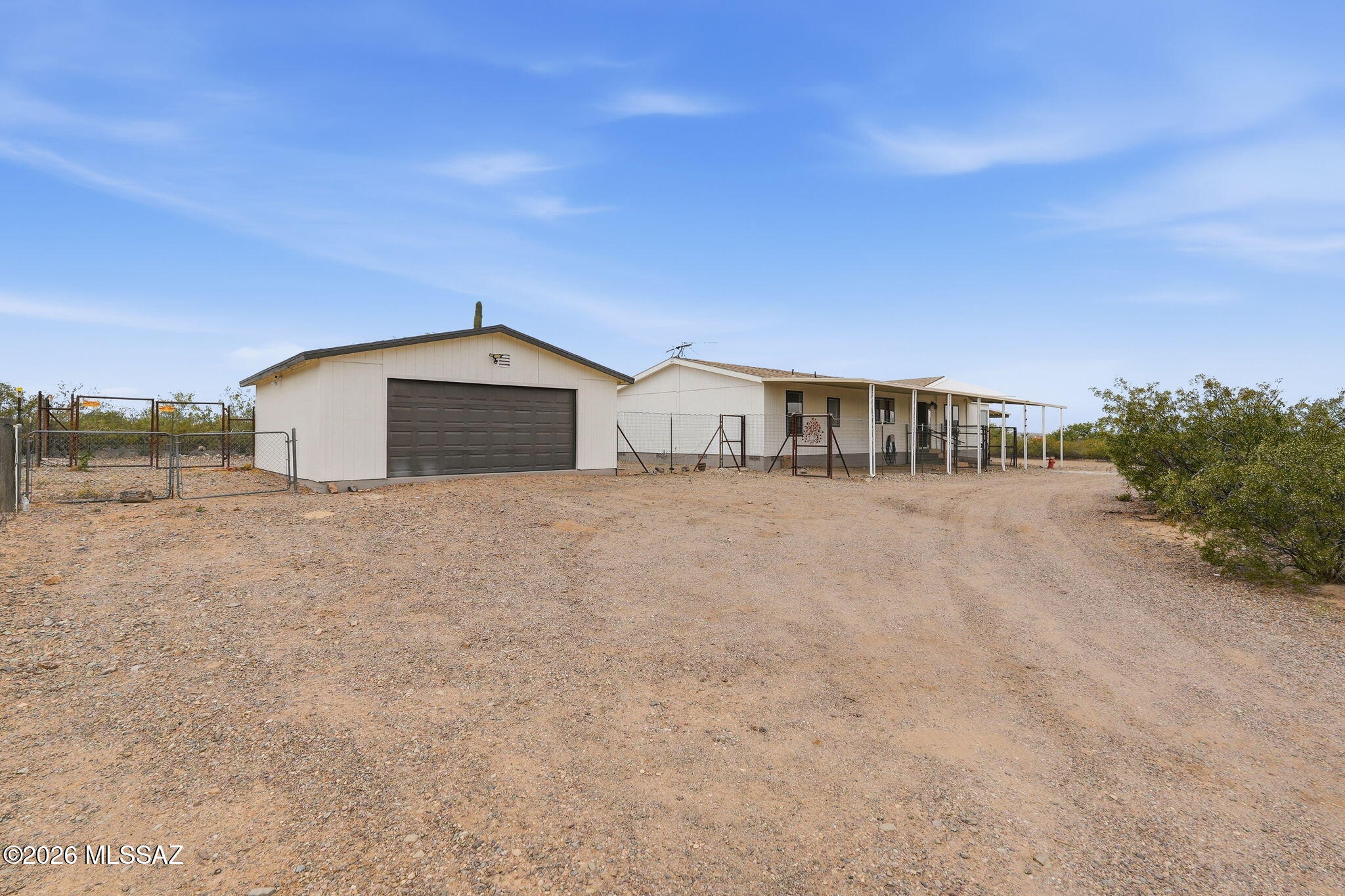 Welcome to your own slice of Arizona paradise sitting on over four acres of wide-open desert land. This spacious three-bedroom, two-bathroom manufactured home offers 2,016 square feet of comfortable living with no homeowners association to tell you what to do. That's right -- your land, your rules.

Step inside and you're greeted by an open floor plan flooded with natural light pouring through oversized windows. The great room features stunning 360-degree mountain views that will make your morning coffee feel like a luxury resort experience. The entire interior has been freshly painted, and on the outside, the color pop accents have been freshly updated too, giving this home serious curb appeal. The kitchen is a showstopper with a beautiful island, tons of counter space, a gas range and newer stainless steel appliances throughout. There's even a casual eating counter plus a dedicated dining area, so whether it's Tuesday tacos or Sunday brunch, you've got room for it all.

The primary bedroom is generous in size and comes with a large closet, plus a bonus room right off the suite that works perfectly as an office or den. The primary bathroom is your personal retreat with a separate garden tub, standalone shower, and double vanity. The guest bathroom doesn't disappoint either, featuring a large countertop with a tub and shower combo. All bedrooms are nicely sized with bigger closets than you'd expect.

Step outside onto the deck accessible from both the laundry room and the great room, making it perfect for indoor-outdoor living. The laundry room also includes handy storage space. Over four acres gives you room to breathe, dream, and build. There's a detached garage, a cement pad ready for projects, and even horse stalls for the equestrian enthusiast in your life.

Here's where it gets even better -- this home comes with owned solar panels, keeping those utility bills incredibly low. The property runs on a shared well, has its own septic system, and a leased propane tank, so you've got everything you need without the hassle of city utilities.

With no homeowners association fees and endless possibilities, this property doesn't come around every day. Schedule your showing and come see what life looks like with a whole lot of elbow room.