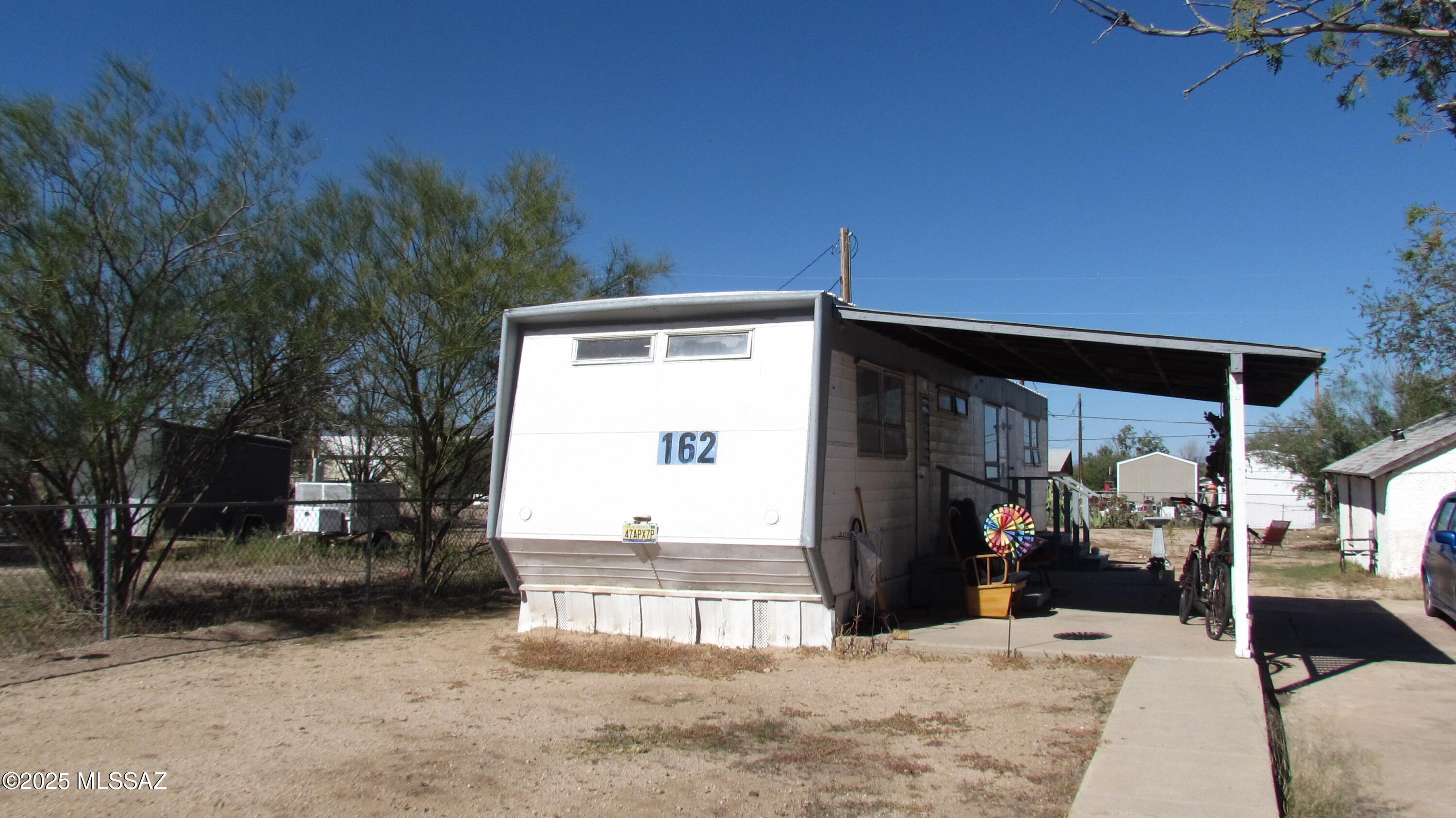 Prime opportunity featuring a vintage 1959 mobile home (1 bed, 1 bath). The property includes a historic adobe structure, perfect for a studio, workshop, or storage. The lot is fully fenced with a wide RV gate, convenient alley access, and secure. Enjoy easy living just steps from a community park, with quick access to I-10 for commuting.