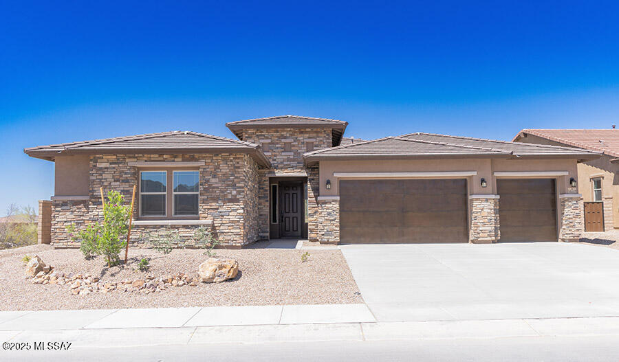 The ranch-style Holbrook plan offers a formal dining room connected to the gourmet kitchen via a butler's pantry. A large quartz kitchen island overlooks the nook and great room, with views of the covered patio. The primary suite includes two walk-in closets and a private bath. A fourth bedroom with an adjacent full bath and two bedrooms with a Jack-and-Jill bath are included.