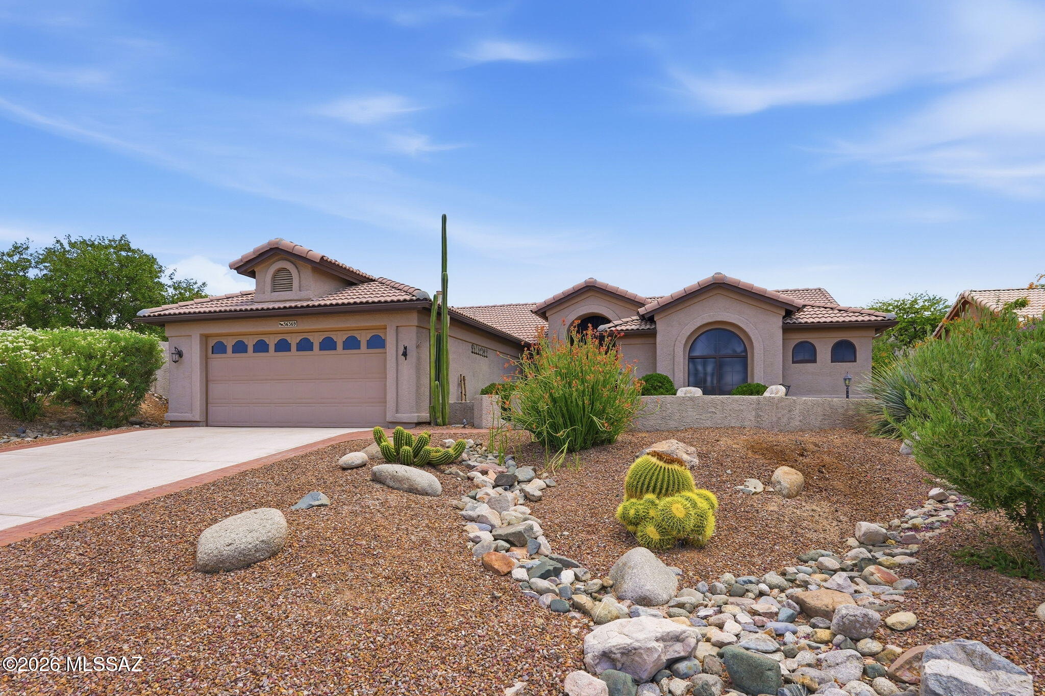 Welcome to your dream oasis in the premier active adult 55+ community of SaddleBrooke! This beautifully maintained 2BD/2BA+Office (2,161sqft) Topaz model with a solar heated Pebbletec pool, perfectly blends sophisticated comfort with the ultimate Arizona indoor-outdoor lifestyle. From the moment you arrive, the home greets you with a spacious front courtyard, the absolute perfect place to sit back, relax, and soak in the peaceful high-desert mornings. Step through the front door to find a light-filled, thoughtful floor plan, featuring tile and vinyl plank flooring and custom window treatments such as rolling security shutters. The heart of the home is a spacious, centrally located kitchen packed with extensive cabinetry, a breakfast nook, and a charming bay window. It flows naturally into a cozy living room and formal dining area, keeping you seamlessly connected with guests. A versatile den serves as the perfect home office, media room, or hobby space to suit your needs. The generous primary suite serves as your private sanctuary, featuring dual sinks, a large walk-in shower, a roomy walk-in closet with custom shelving and drawers, and its own private door leading out to the rear patio. Visitors will feel right at home in the spacious guest bedroom. Outdoor living is a true resort-class experience. The backyard faces east, treating you to comfortable afternoon shade on the flagstone patio and gorgeous morning sun over your own private, solar heated Pebbletec swimming pool. Complete with rolling security shutters, a separate laundry room, this turnkey, furnished residence leaves nothing to be desired. Enjoy world-class golf, tennis, and social clubs right at your fingertips!