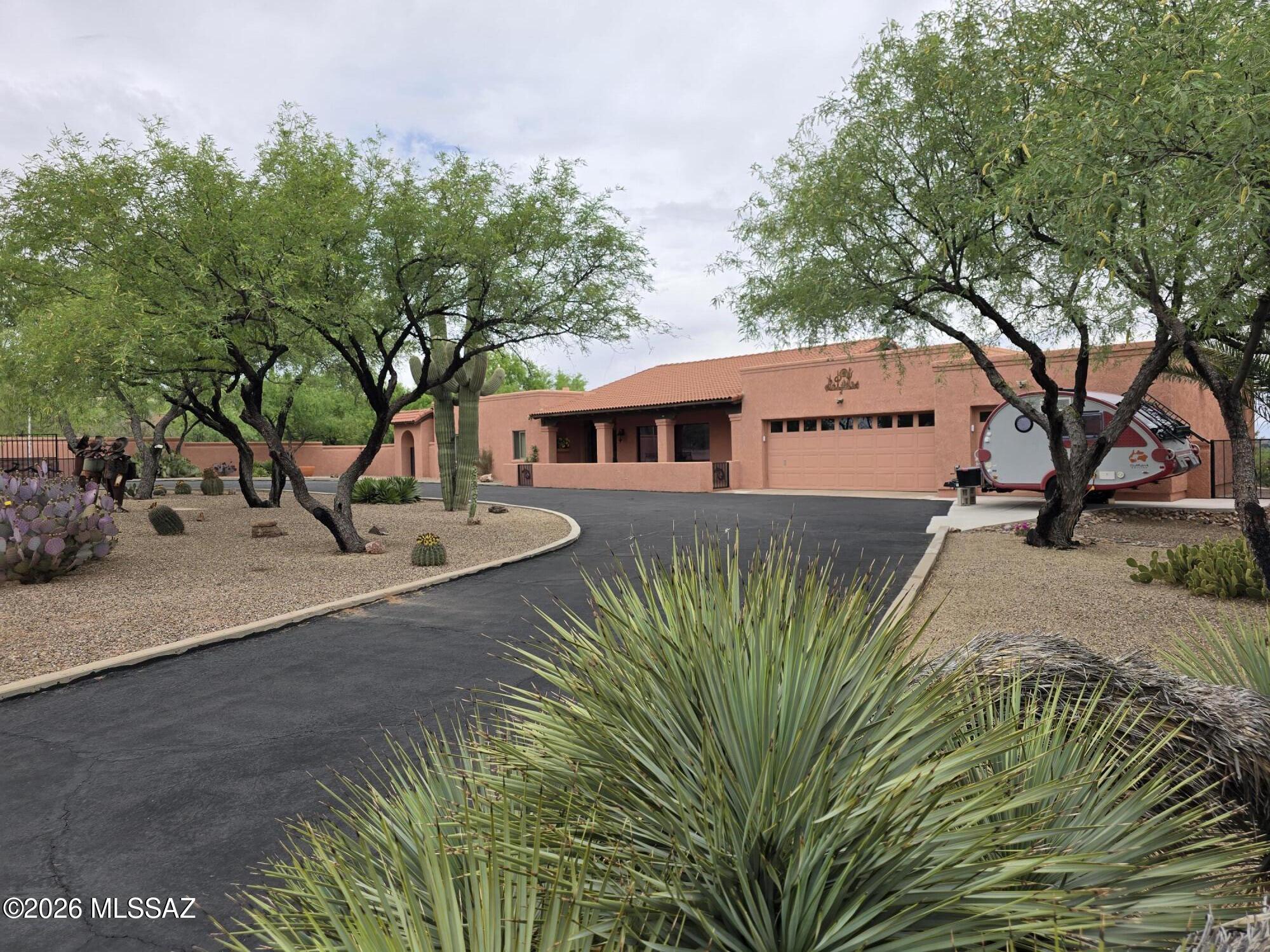 Picturesque home located on the West side of Tubac on 1.43 acres, has 2637 sf of custom home features and views from every room. 2 large bedrooms and an office equipped with a Murphy bed, fireplace and spacious room for guests. Entertain on your large back Covered Patio and enjoy the beautiful Mountain Scenery of Elephant Head and Mt Whipple Observatory. A large kitchen with eat in dining space and Natural Mexican Contera Stone. Formal dining area and great room concept along with 14' vaulted wood beamed ceilings. 3 car garage, 3 gas fed fireplaces NO HOA! Come and see this Gorgeous Southwest Ranch Style home today!