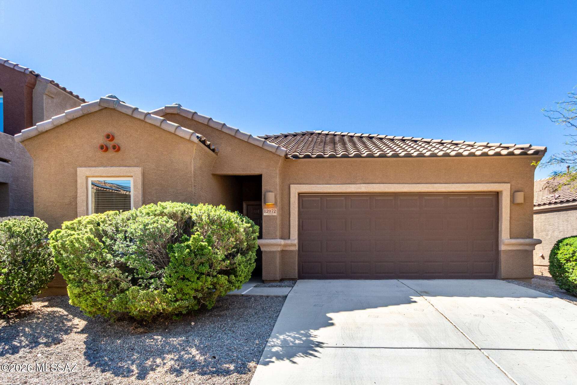 Welcome to this beautifully maintained single-story home in the desirable Vista Del Lago Norte community of Vail, Arizona, located within the highly sought-after Vail Unified School District. This home features three bedrooms and two full bathrooms with a smart split-bedroom layout, offering both privacy and functionality. The spacious 1,500 sq ft floor plan includes nine-foot ceilings and tile flooring throughout the main living areas. The open-concept great room flows seamlessly into the kitchen, which is equipped with granite countertops, a large island with seating, stainless-steel appliances, and ample cabinet storage. The primary suite offers a private bathroom with dual sinks, a walk-in shower, and generous closet space. Step outside to a fully fenced backyard complete with a covered patio and a fire pit, perfect for relaxing or entertaining. The home sits across from a neighborhood park, providing playgrounds, shaded picnic areas, and open space for family activities. Built in 2020, this home offers a 2-car attached garage, desert landscaping, and curb appeal, along with proximity to shopping, dining, parks, and easy access to Tucson. Move-in ready with thoughtful upgrades, this home provides the ideal combination of comfort, style, and location in Vail.