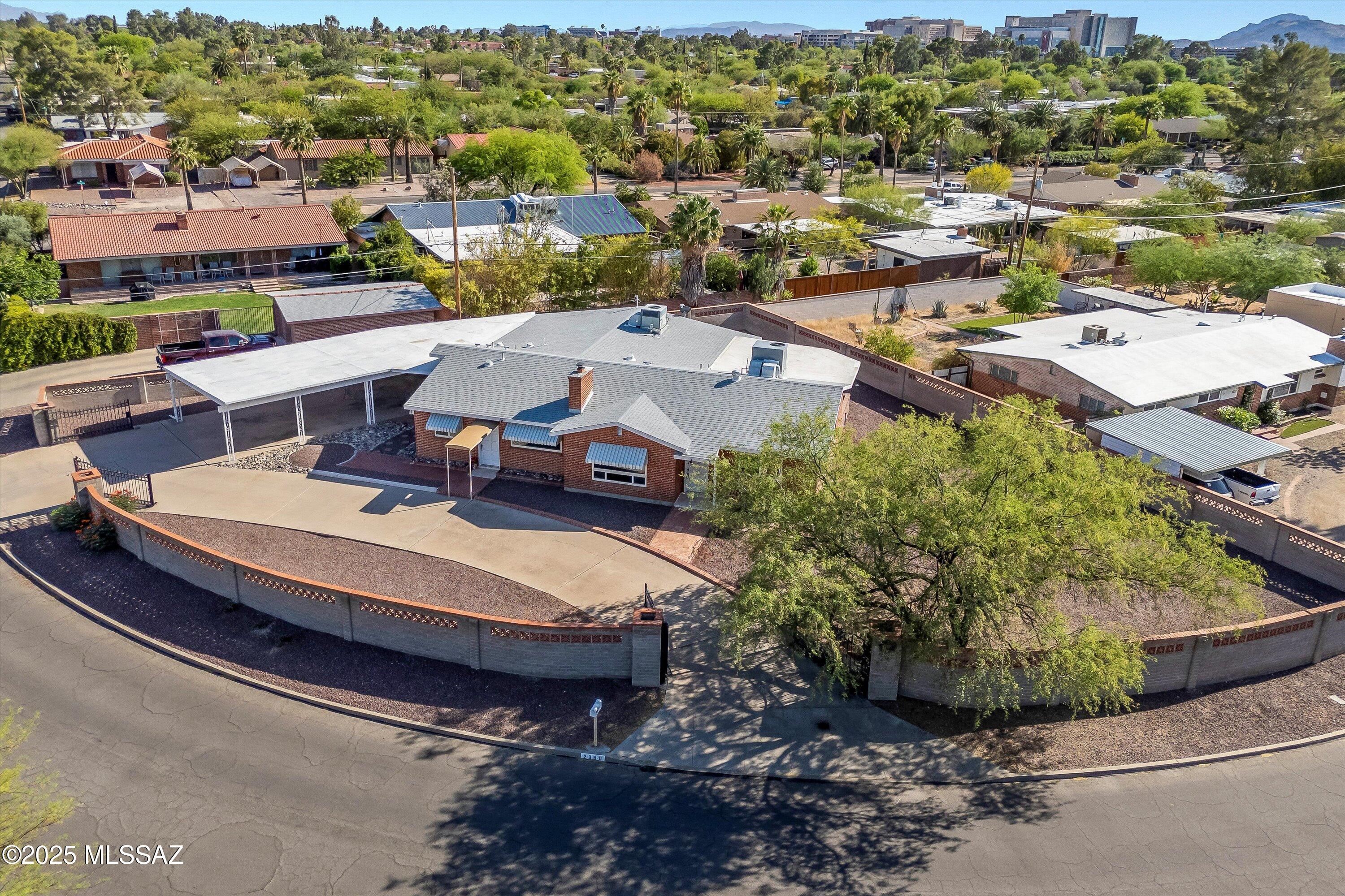 Beautiful Mid-Century Gem in Historic Catalina Vista! Nestled on a gated corner lot spanning over a third of an acre, this property offers an unmatched sense of space and privacy. Step inside to discover a light-filled interior featuring four bedrooms and three bathrooms, thoughtfully designed with a split bedroom floor plan. The gourmet chef's kitchen is a dream for culinary enthusiasts, while two separate living areas provide plenty of room for relaxation and entertaining. Need a guest suite or home office? The versatile fourth bedroom boasts its own bathroom and private entrance, making it perfect for guests, a rental, or a dedicated workspace. Outside, the low-maintenance yard is a blank canvas for your vision, complete with a covered patio and ample space for a pool. And let's not forget the rare 4 car carport - a true bonus in this prime central location! Just minutes from the University of Arizona, Banner Medical Center, shopping, and Tucson's top-rated restaurants! Motivated Seller!