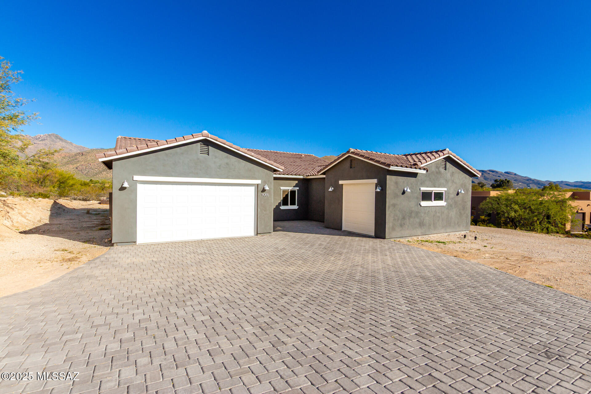 Experience luxury desert living in this brand new 2,543 square foot home, perfectly situated on a .83 acre lot in a private cul-de-sac with only two other homes, all newly built in 2025. This 4 bedroom, 2.5 bathroom residence features elegant tile flooring throughout and quartz countertops in both the kitchen and bathrooms, blending modern style with lasting durability. The open concept layout offers spacious living and dining areas ideal for entertaining. A 3-car garage provides ample storage and parking. Enjoy breathtaking 180 degree Catalina Mountain views from the backyard, creating a serene and private desert retreat. Thoughtfully designed and beautifully finished, this home offers comfort, privacy, and refined desert living. Schedule your showing today before it's gone!