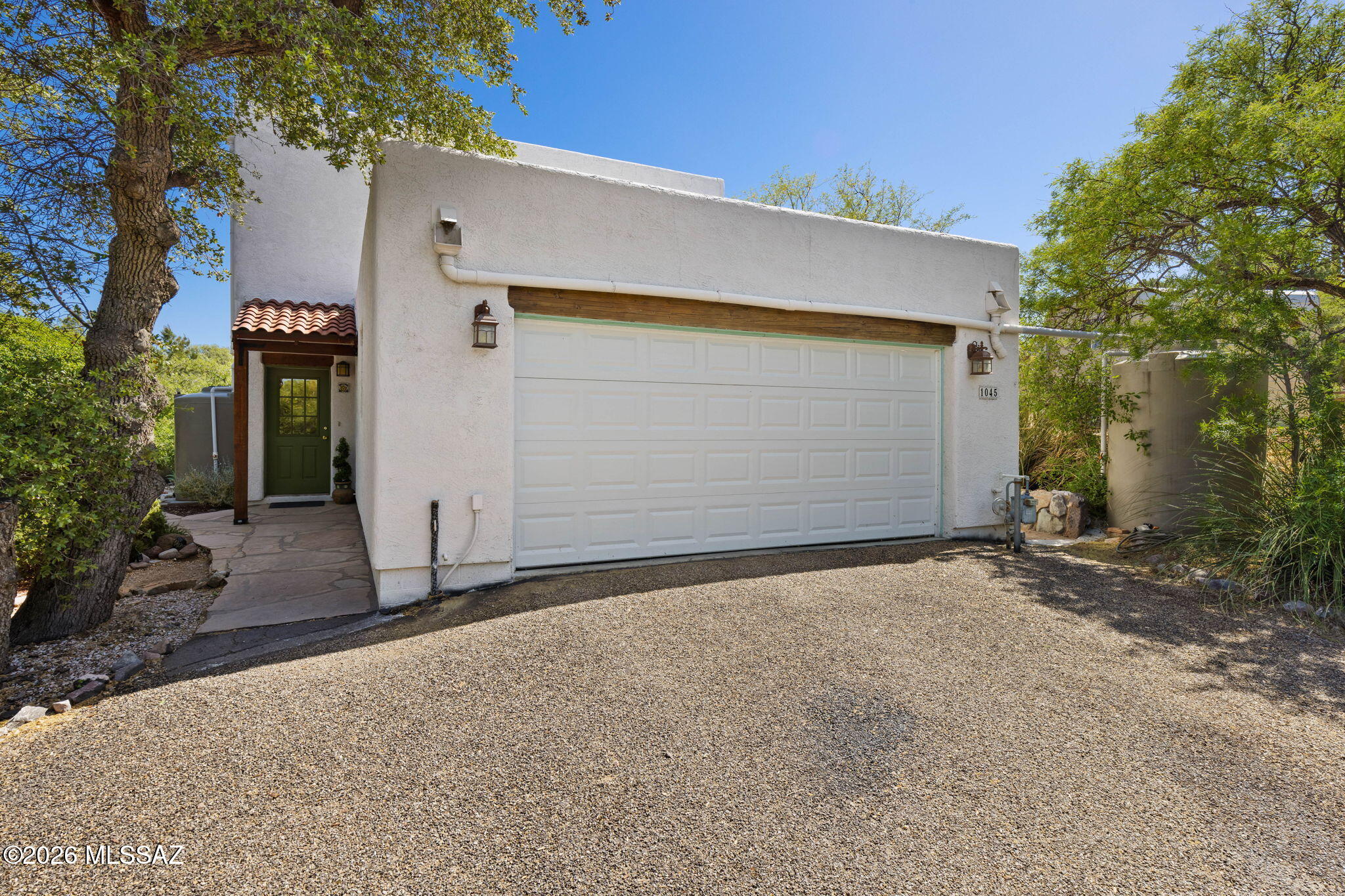 Seller to entertain/counter offers from $475k-$500k. This is your opportunity to own your own home with panoramic views in Oracle. This impressive home features 3 bedrooms (possibly more) and 4 bathrooms and is ready for you to make your own. This property has 2,306 sq ft on 0.57 acres and offers breathtaking panoramic mountain views. The main house is 1,624 sq ft. It was built on a corner lot, has no HOA, and offers endless possibilities. Sitting high above the street you will be impressed by this property's grandeur. Set back from the road, it has plenty of room for parking. As you step through the front door into the foyer, you will see the impressive staircase leading upstairs. The home is perfect for a large family, generational living or multi-family use. With three separate entrances, privacy is guaranteed. The fully functional kitchen includes a large island with storage. It includes built-in glass cabinets, stainless steel appliances and a large walk-in pantry. The Great Room is the main living area and has a wall of windows showcasing the beautiful green landscape--a perfect area for relaxing by the fireplace on chilly winter nights. It opens to the Dining area and the back patio making entertaining a breeze.  Also downstairs is a guest powder room with laundry facilities for your convenience and huge storage under the stairs. Heading upstairs to the Bedroom level, you will find 3 large bedrooms and two bathrooms. All bedrooms have great closets and storage space. The owner's suite has a luxurious ensuite bath featuring a large stylish tiled shower, double vanity and soaking tub. There is also a walk-in closet with a ceiling fan. The primary suite also has its own private extended balcony patio, where you can enjoy those panoramic mountain views. Stepping outside you will find Unlimited outdoor space with established trees, rainwater collection and a covered garden area/chicken coop. Enjoy calming sunrises & sunsets while taking in the lush green countryside and impressive granite boulders on the property. With all the patio areas and a private deck, make the most of true Arizona outdoor living. And don't forget to bring all your toys, such as an RV, ATV, and boat. There is plenty of space! Over half an acre of land and remember, there are no HOA restrictions.  Additionally, the property's extra buildings offer unlimited potential. The large rammed earth building (682 sq ft) could become guest quarters rental, an Airbnb, a bed and breakfast, a vacation rental or even housing for a growing family.  This building has solar electric, propane gas, and a bathroom. The second building could be used for storage or as another guest house. There is potential for a great investment opportunity.  Located in Pinal County, the property is conveniently close to schools, restaurants, Way Of Bean Coffee Shop, recreation, medical facilities, I-77 Highway and so much more. Highly Motivated Seller - So Call today for your private showing.